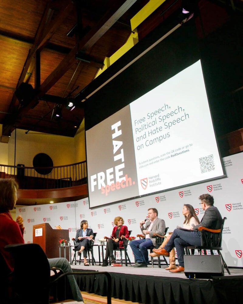 Panelists on a stage.