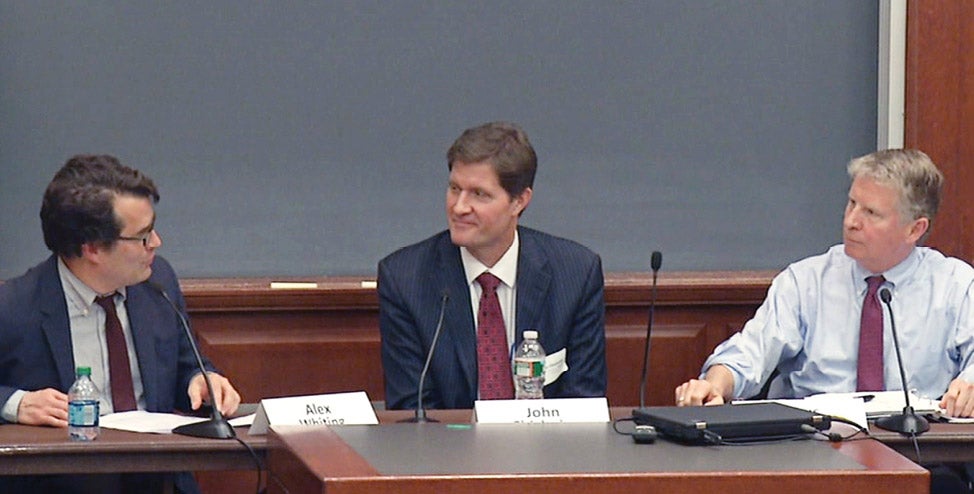 Alex Whiting, District Attorneys John Chisholm and Cyrus Vance speaking at a table