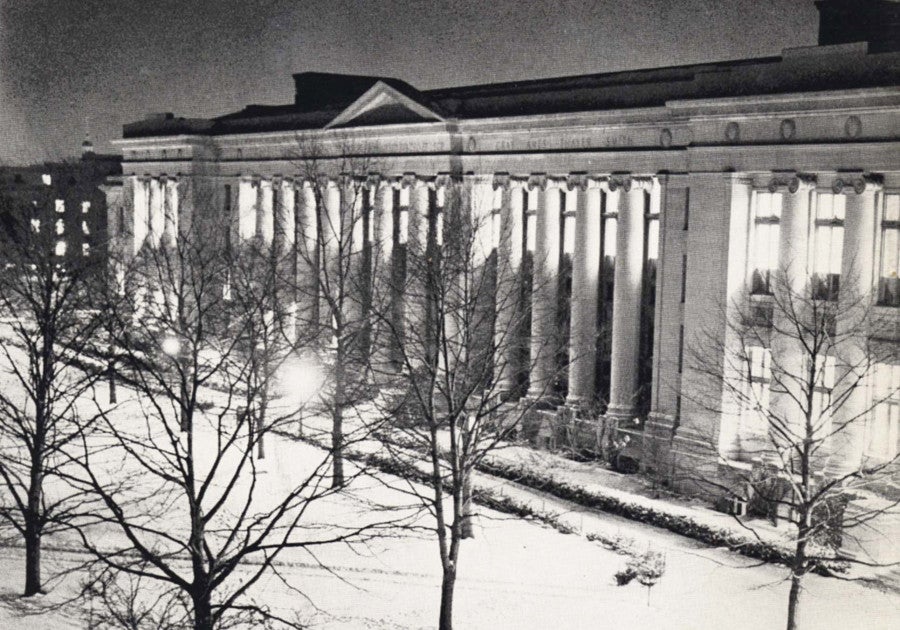 A black and white photo of a snowy Langdell at night