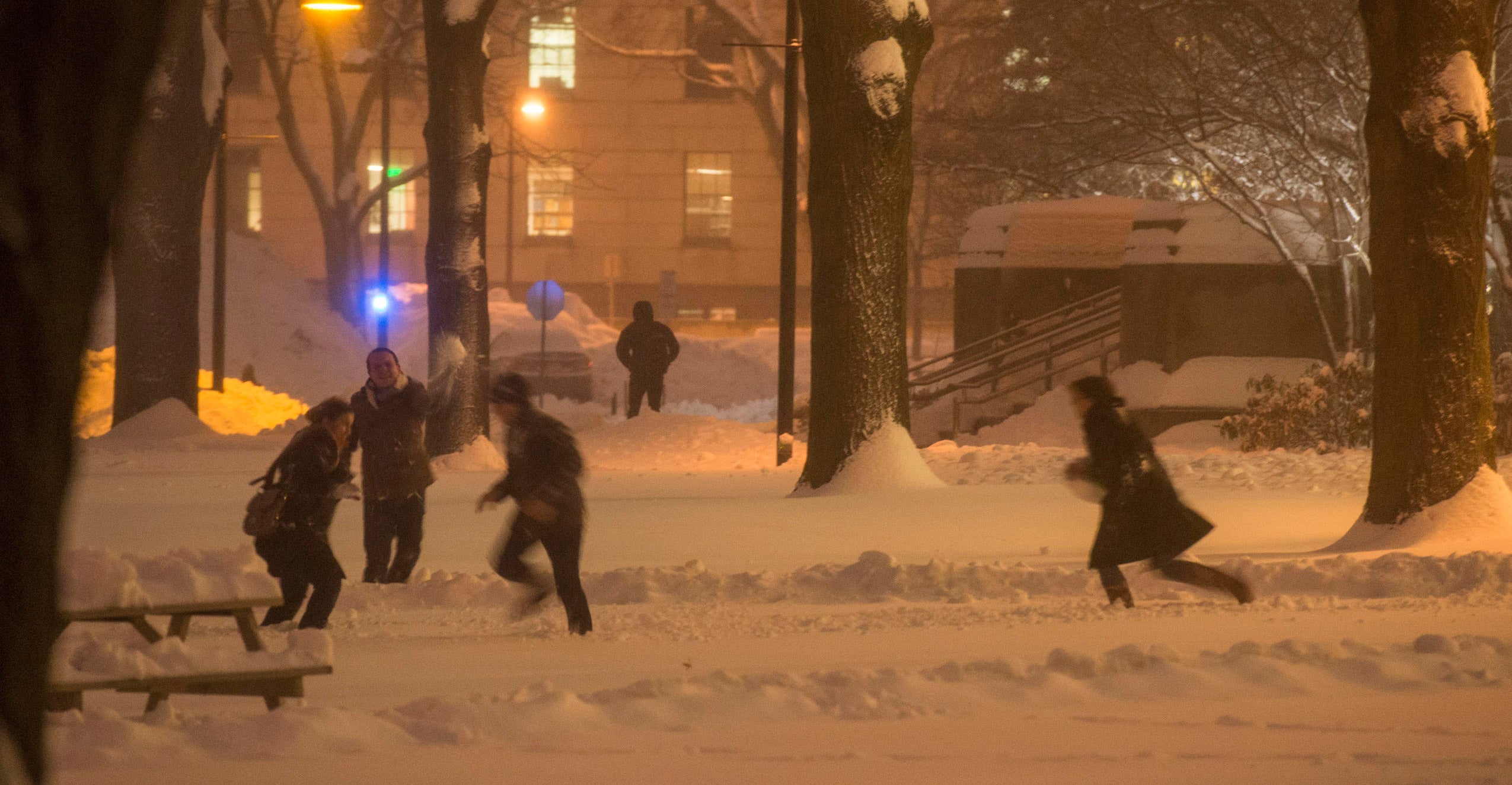 Students playing in the snow on Holmes Field