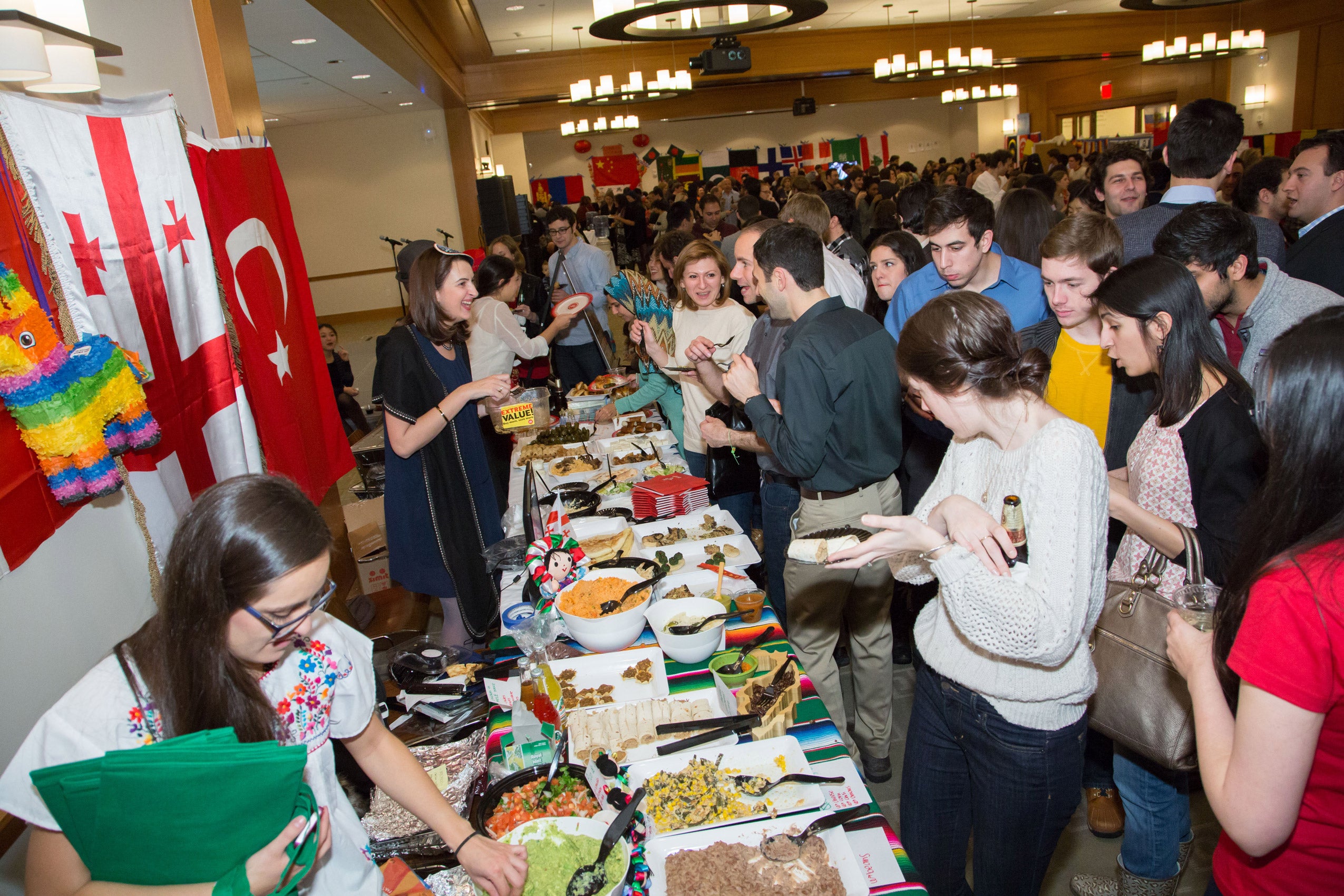 Students approaching tables filled with food