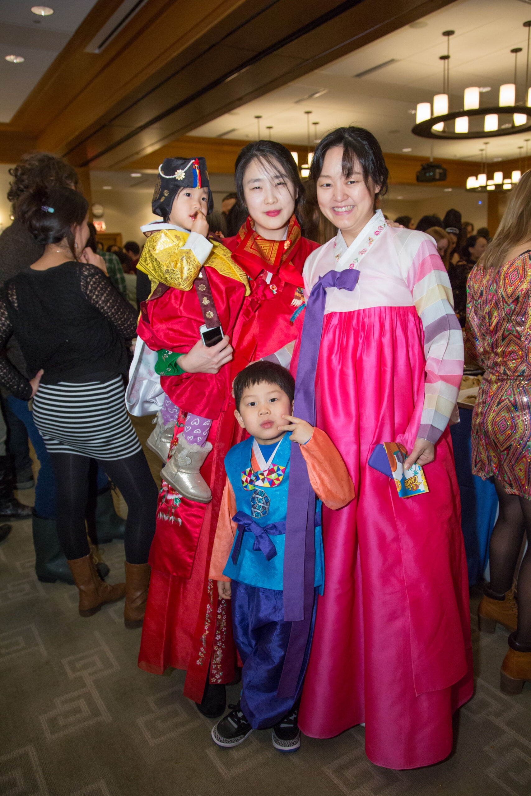 A group of two women and two children posing together