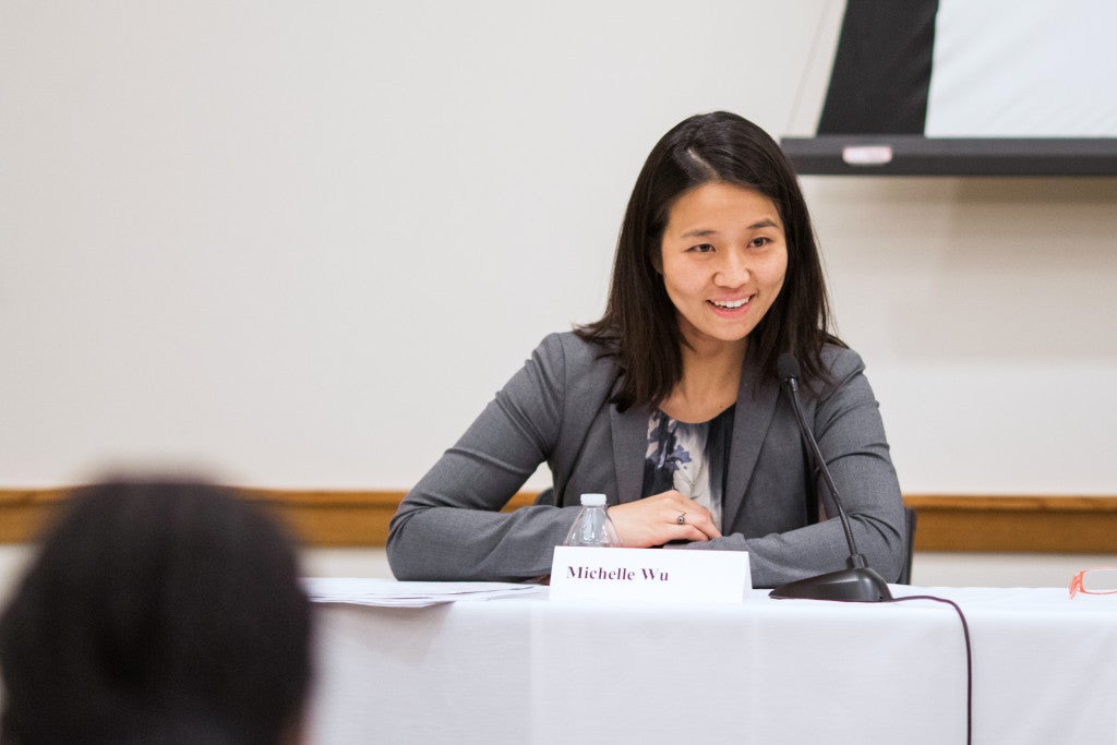 Michelle Wu speaking at a desk