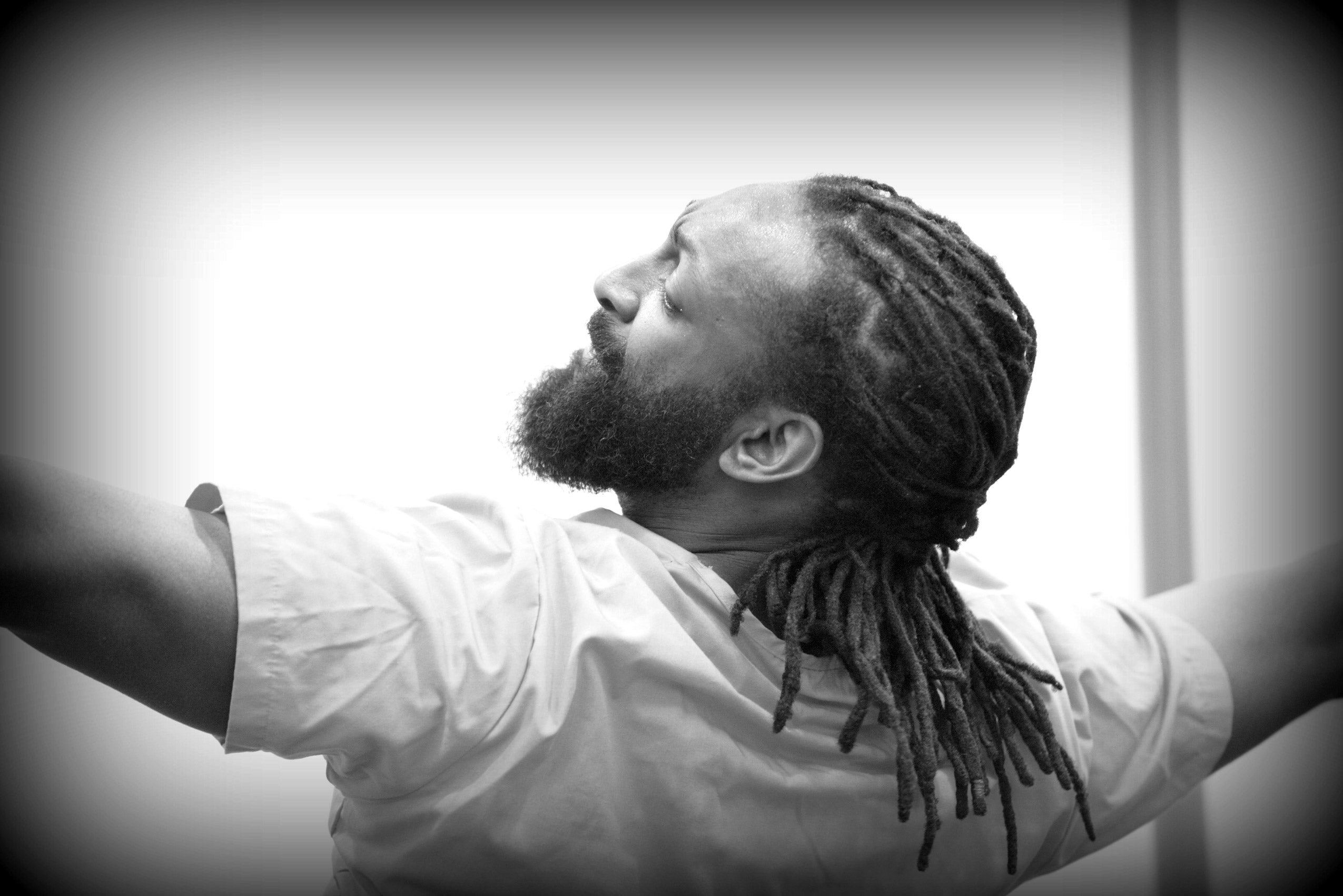 A man with his back to the camera and his arms outstretched