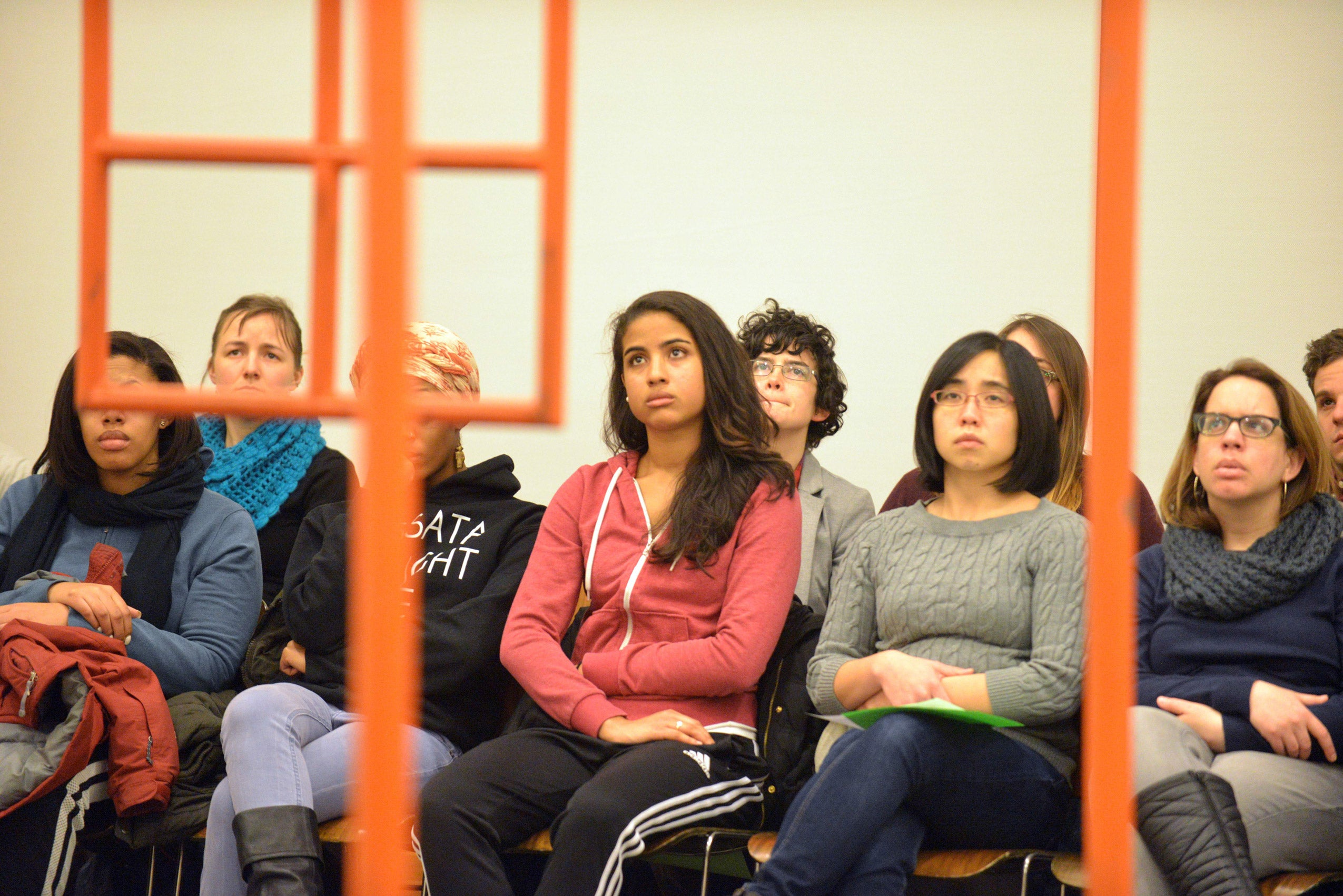 An audience of students watching a performance