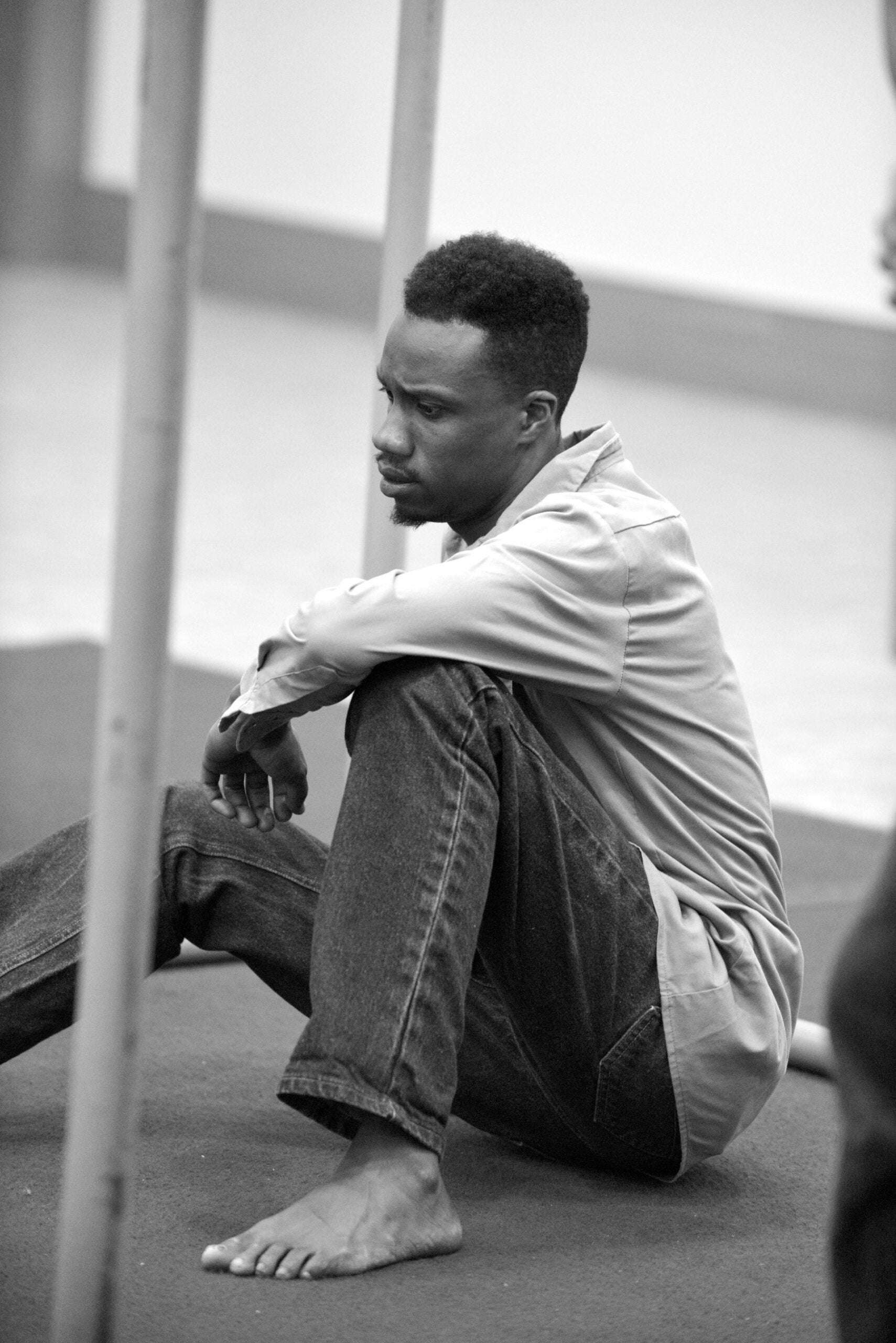 A man seated on the floor