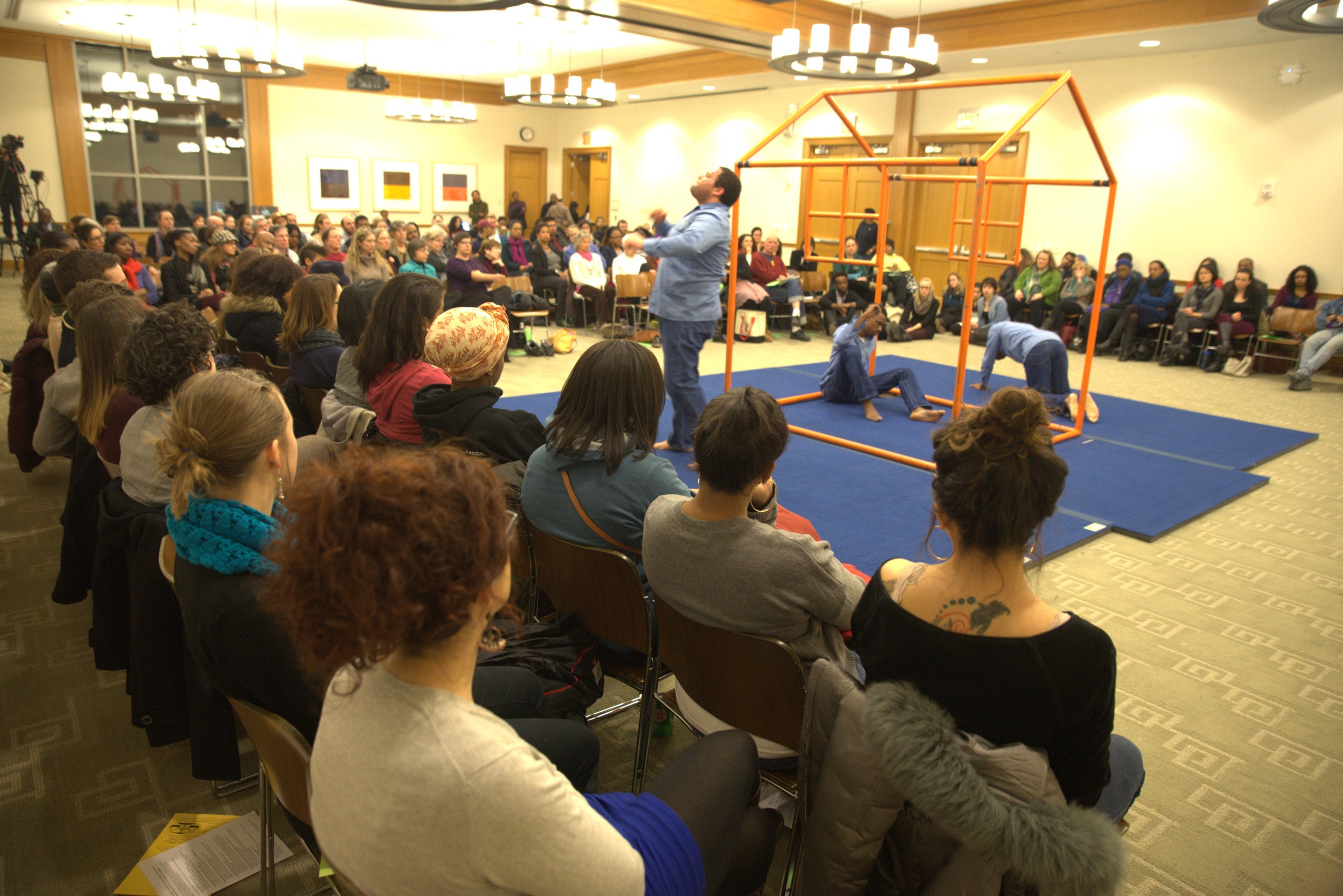 An audience watching on as a performance happens