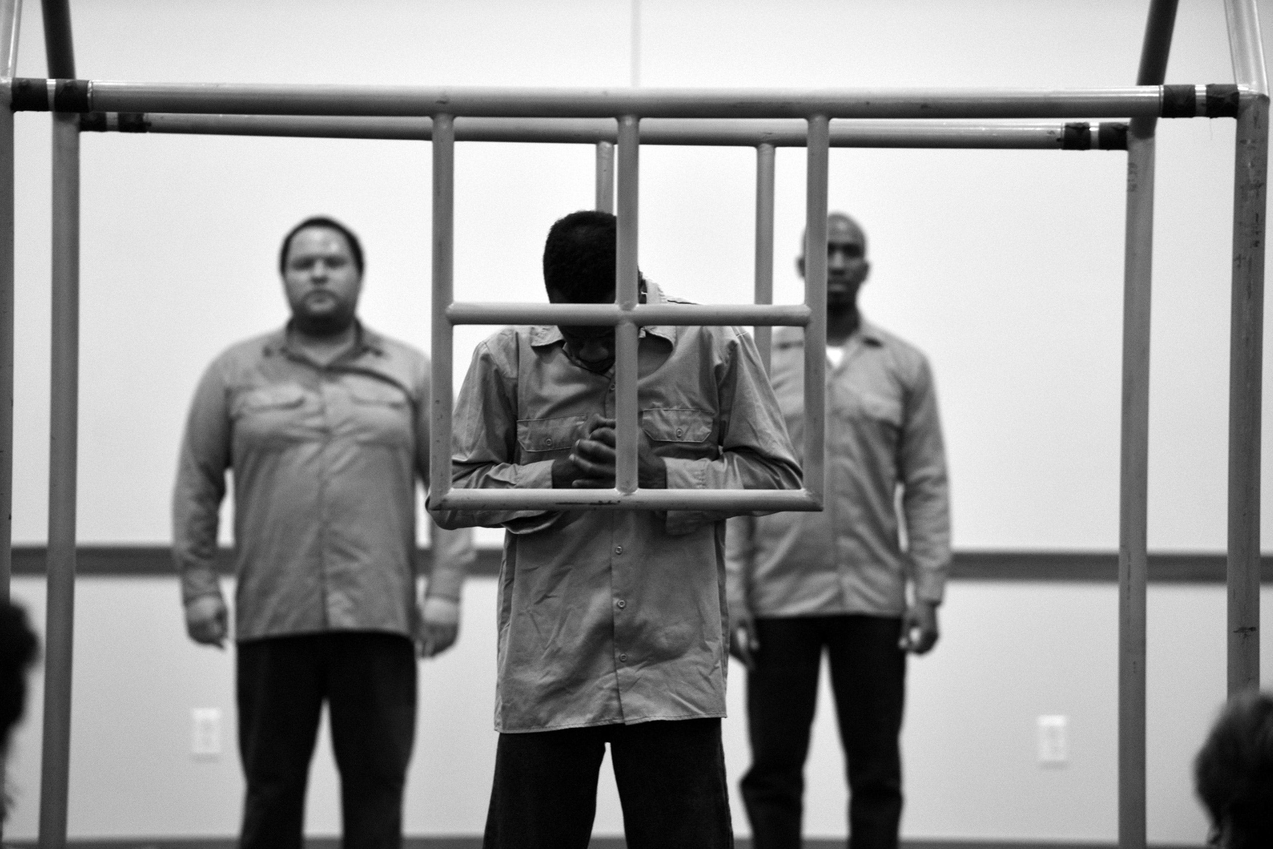 Three men performing with a house shaped prop