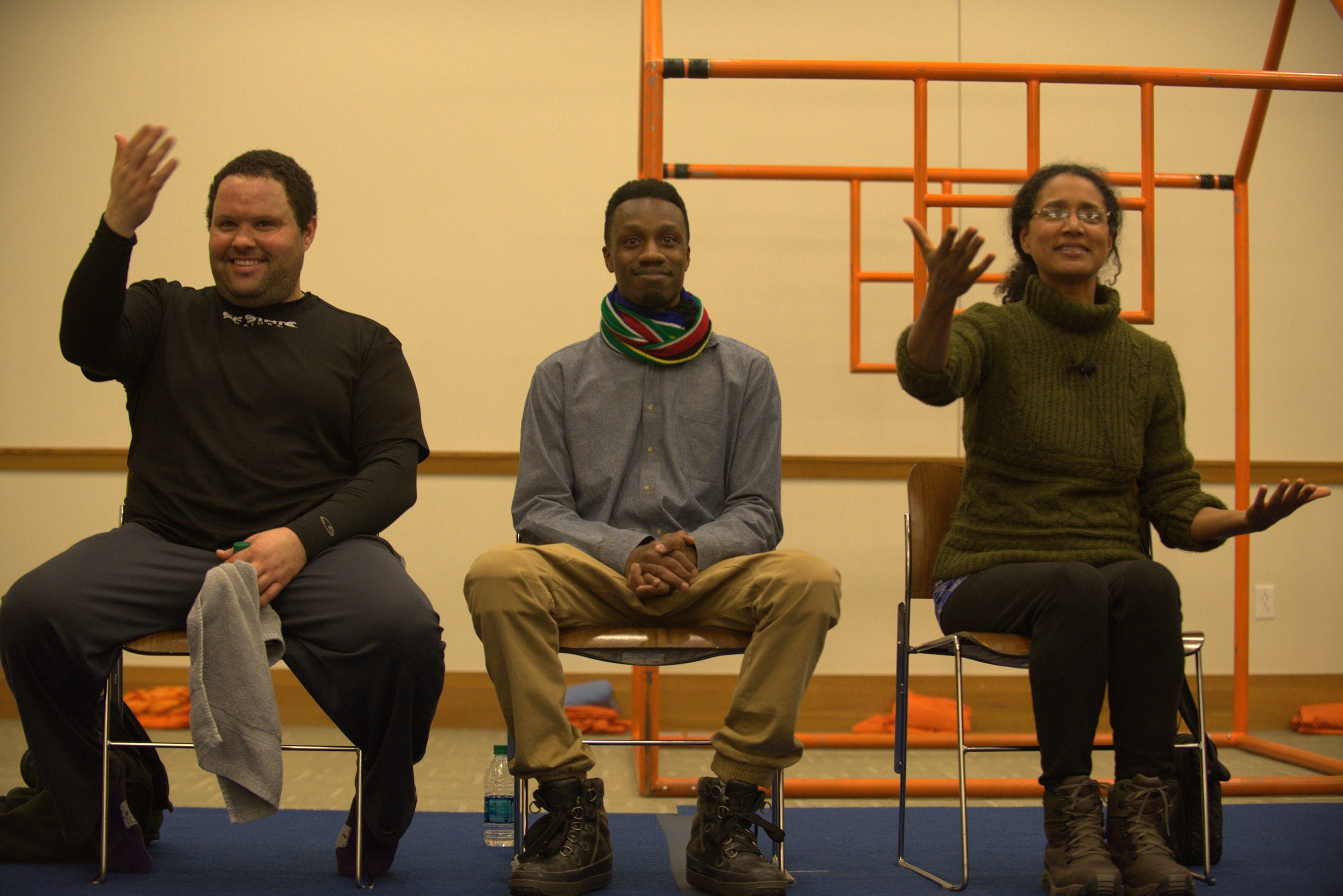 Two men and a woman sitting and performing