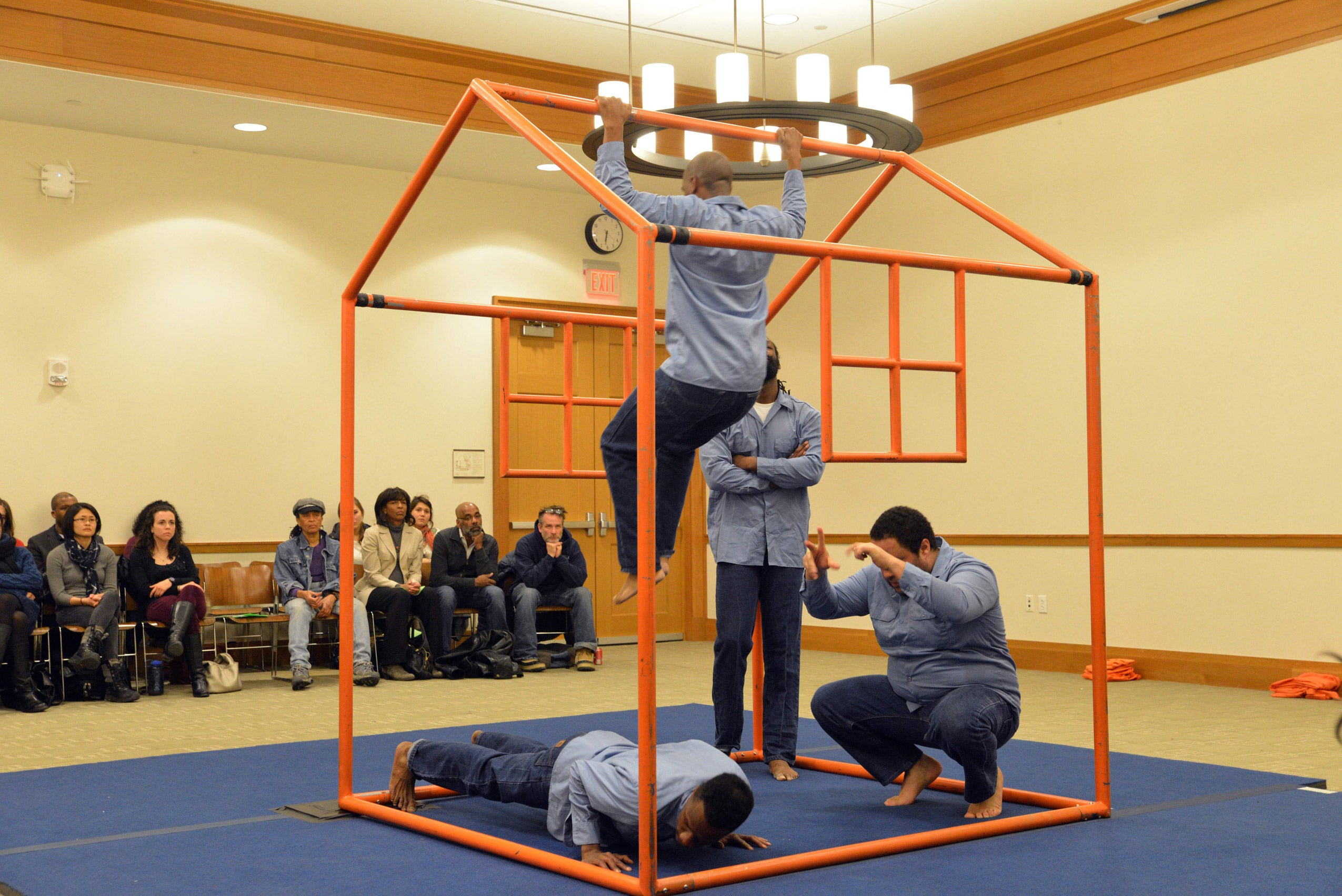 Four men performing with a house shaped prop