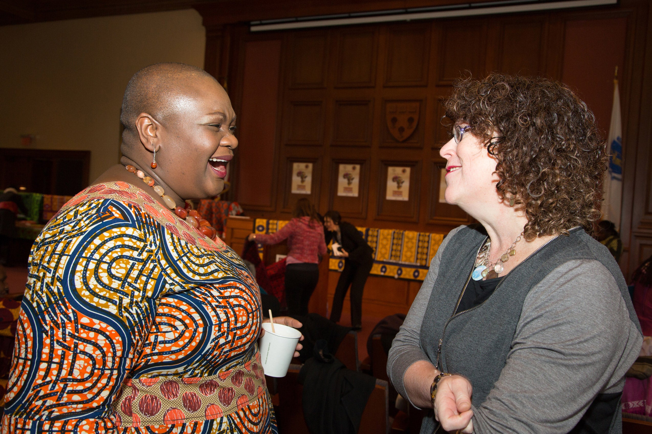 Two women standing together and talking