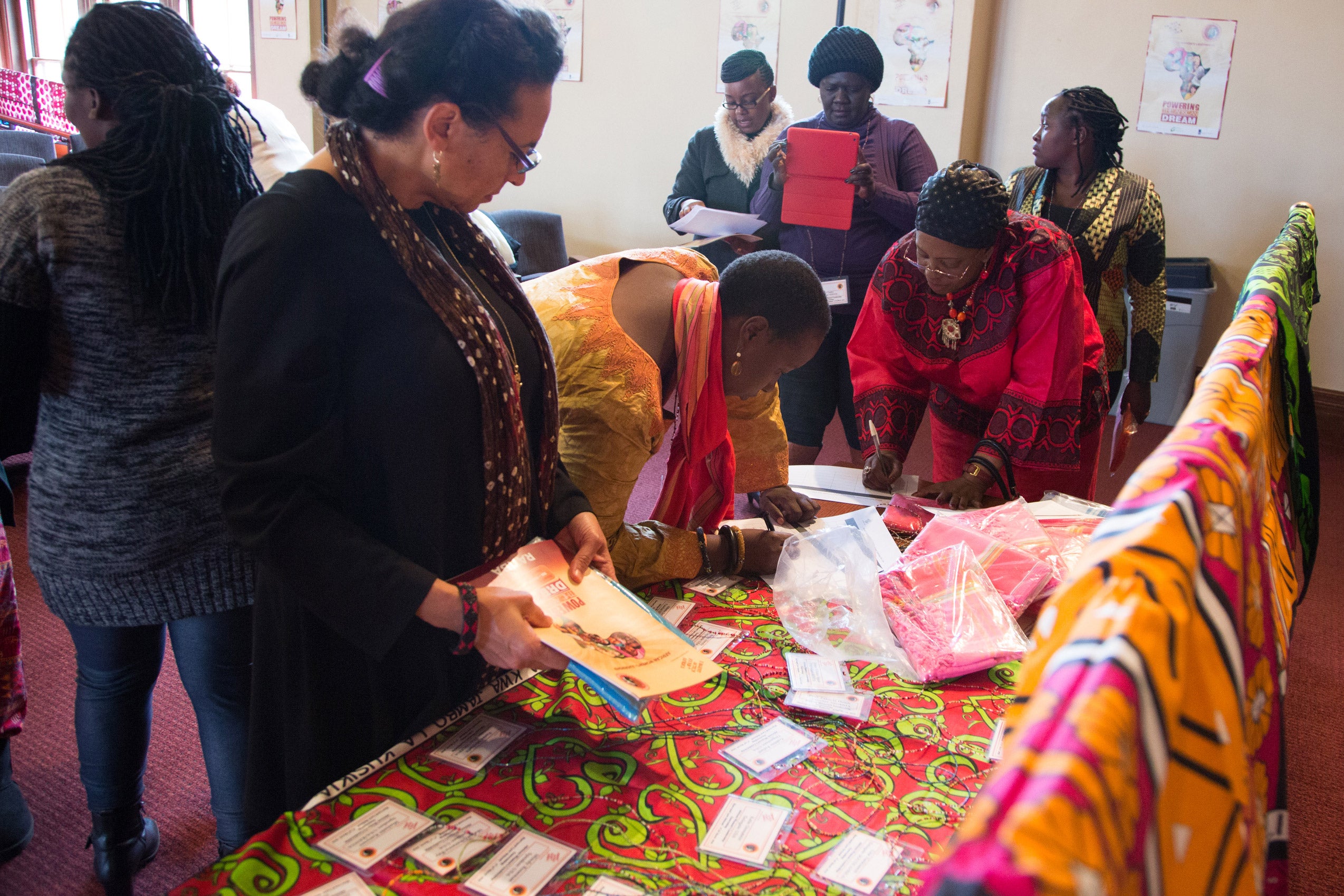 A group of women examining objects on a table