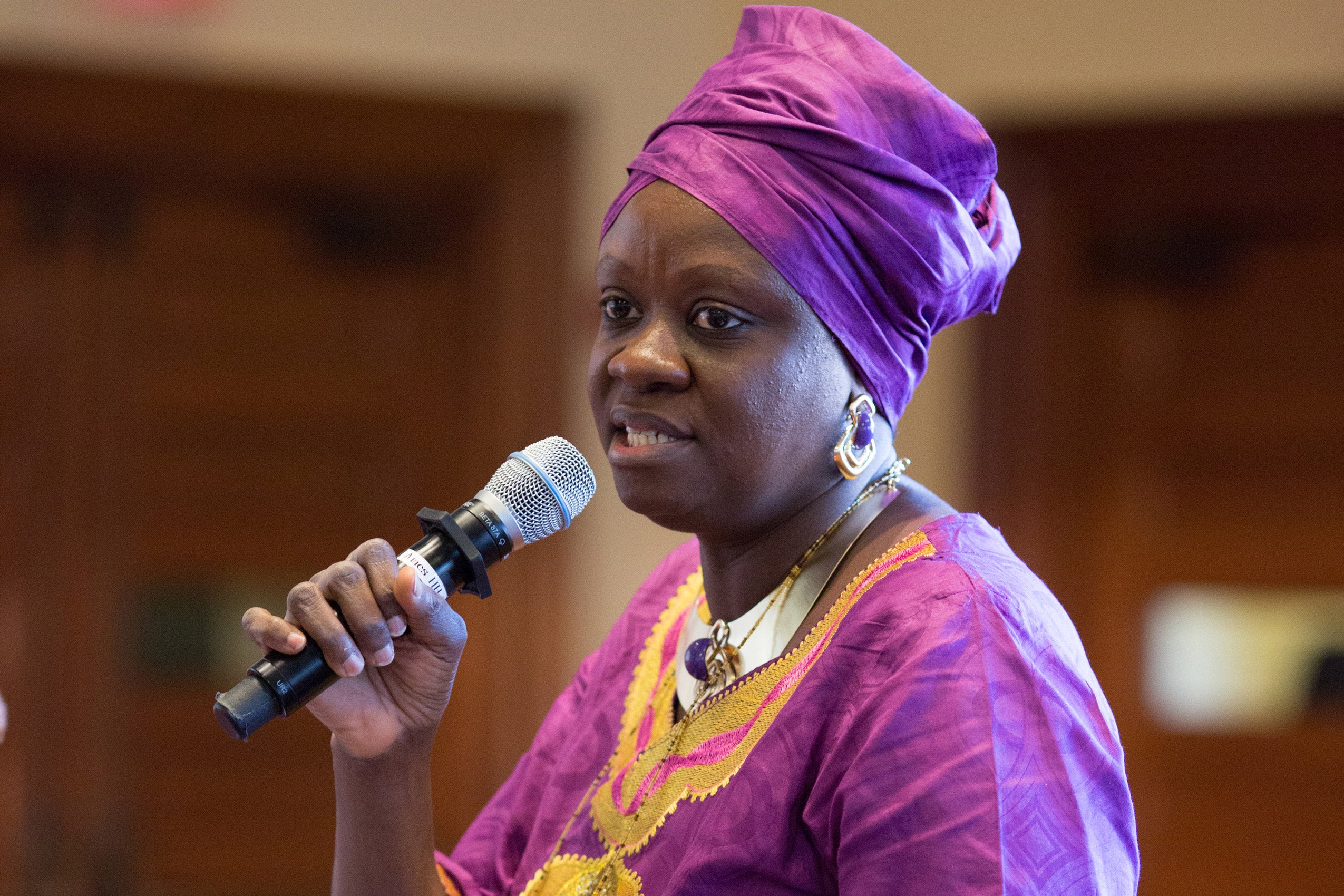 A woman speaking into a microphone