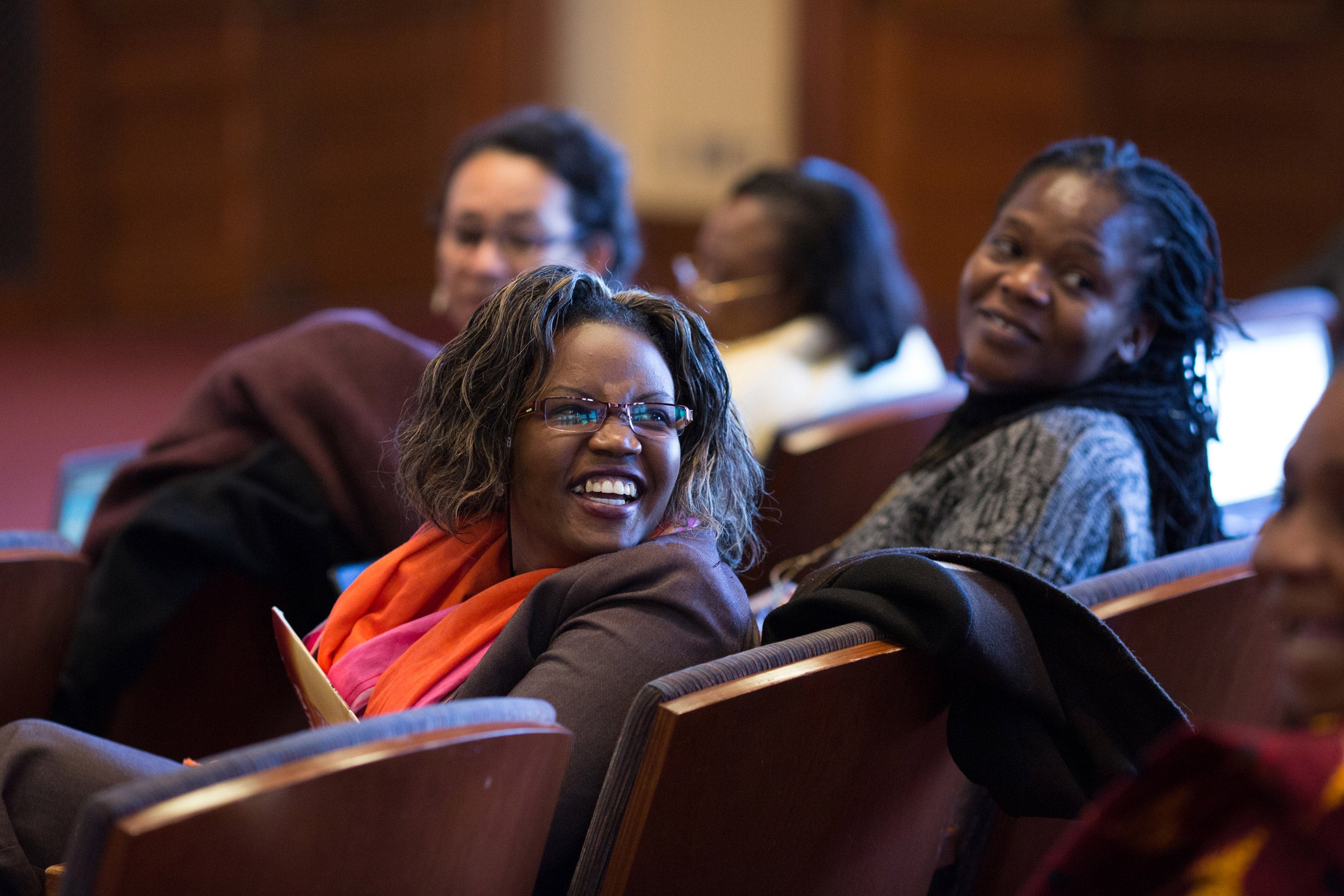 Two women sitting together in the audience