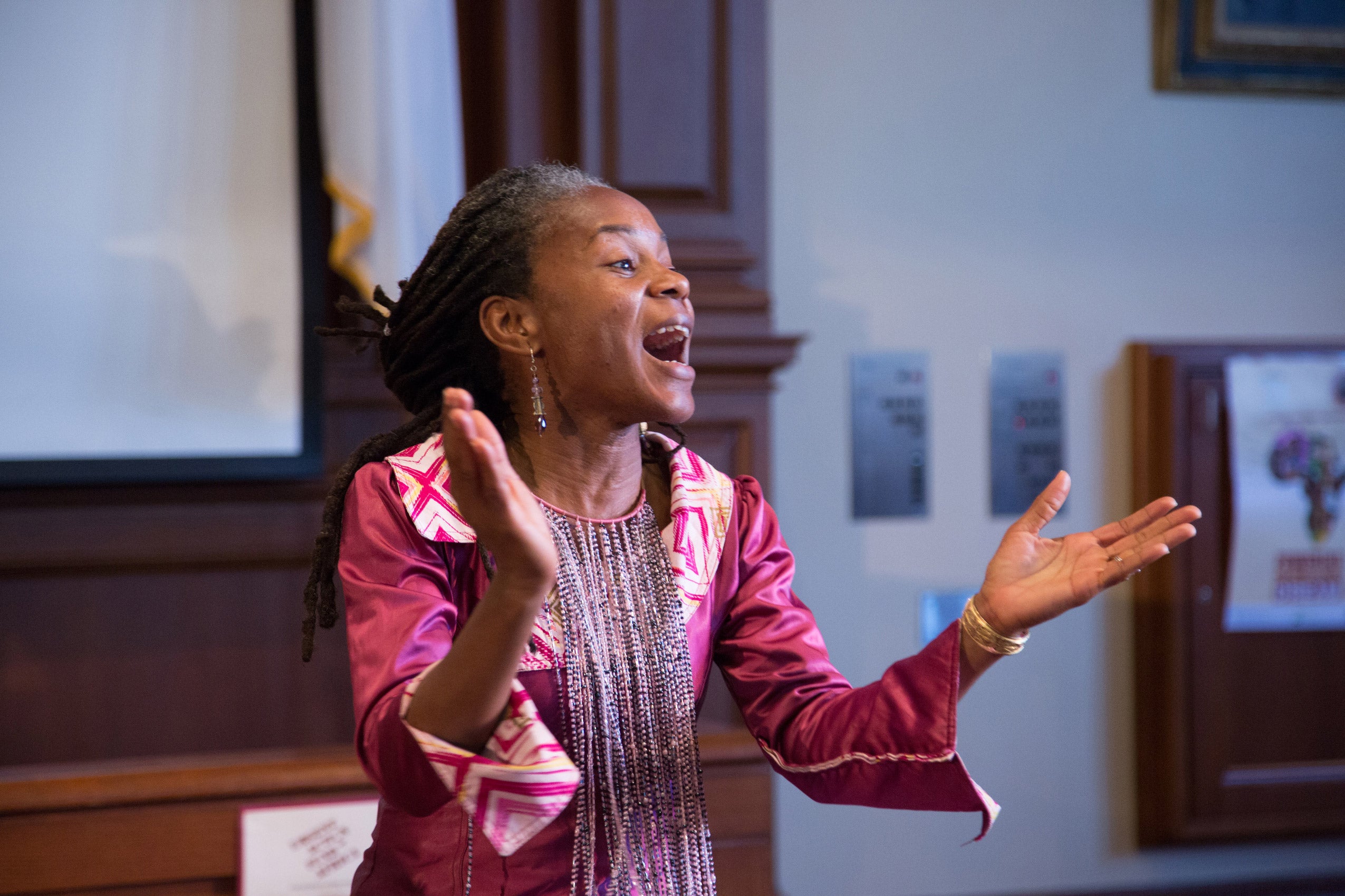 A woman singing and clapping