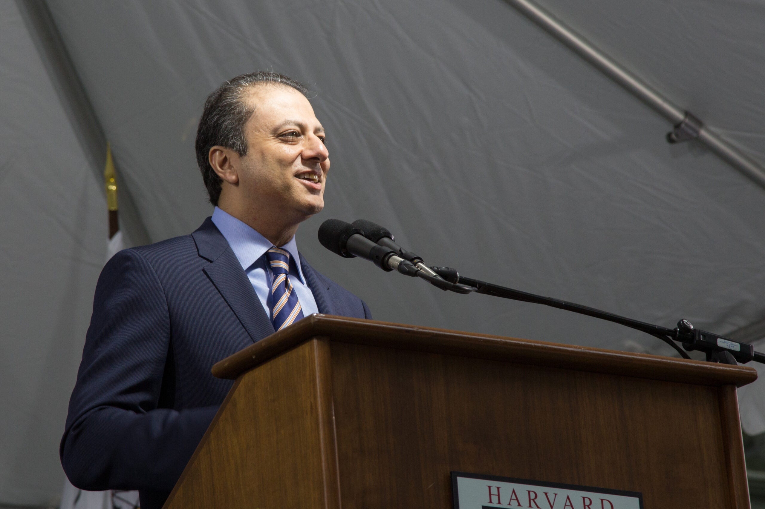 A man speaking into a microphone at a podium