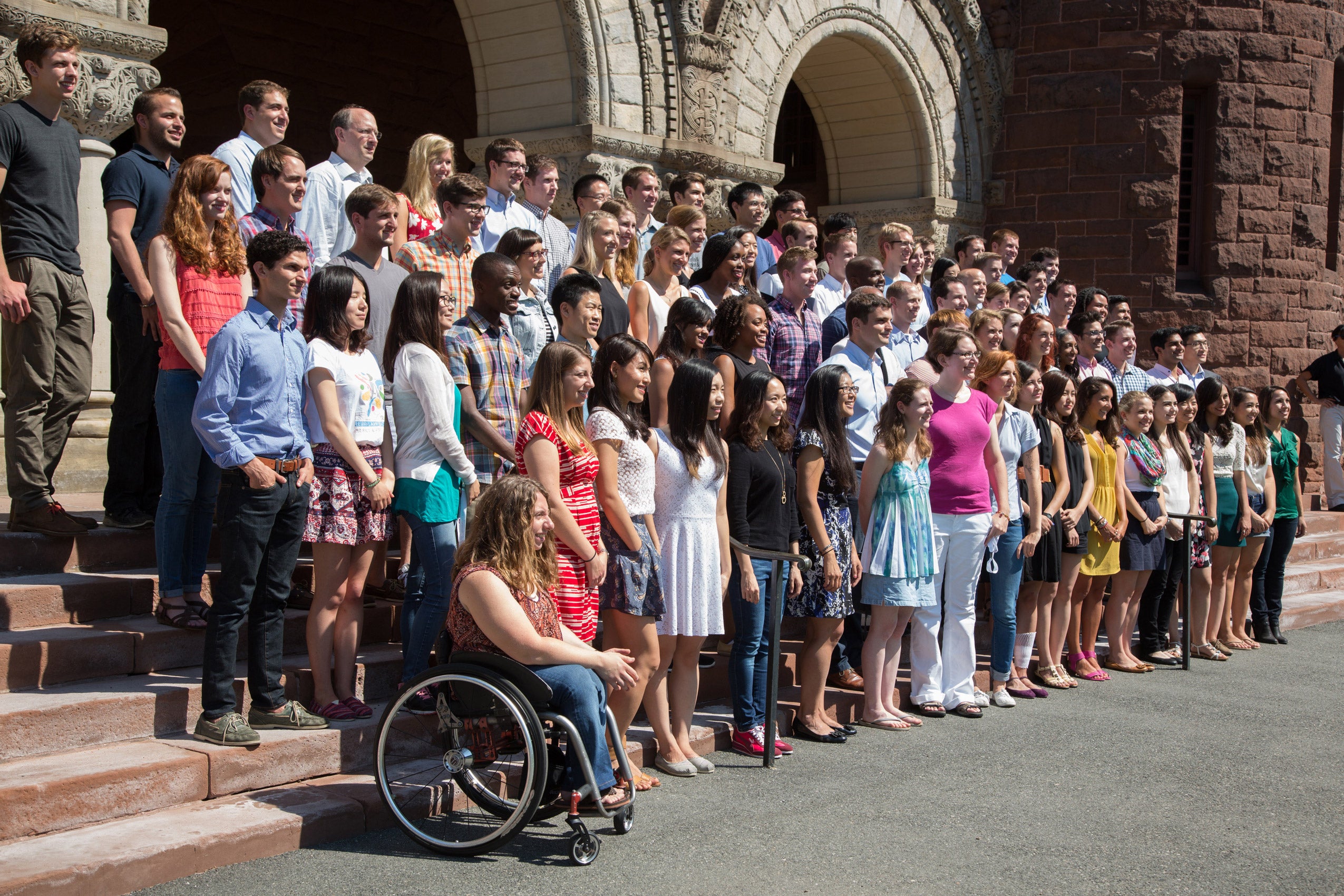 A group of new students posing together on the steps of Austin Hall