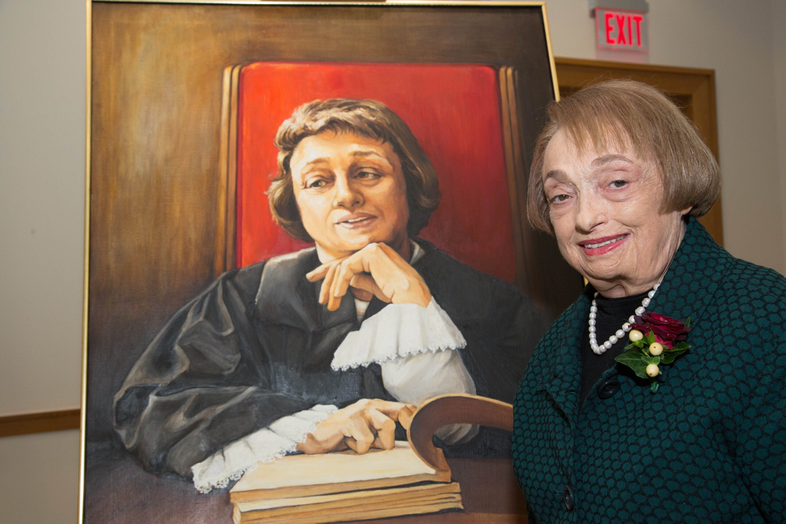 woman standing next to a painting of herself as a judge
