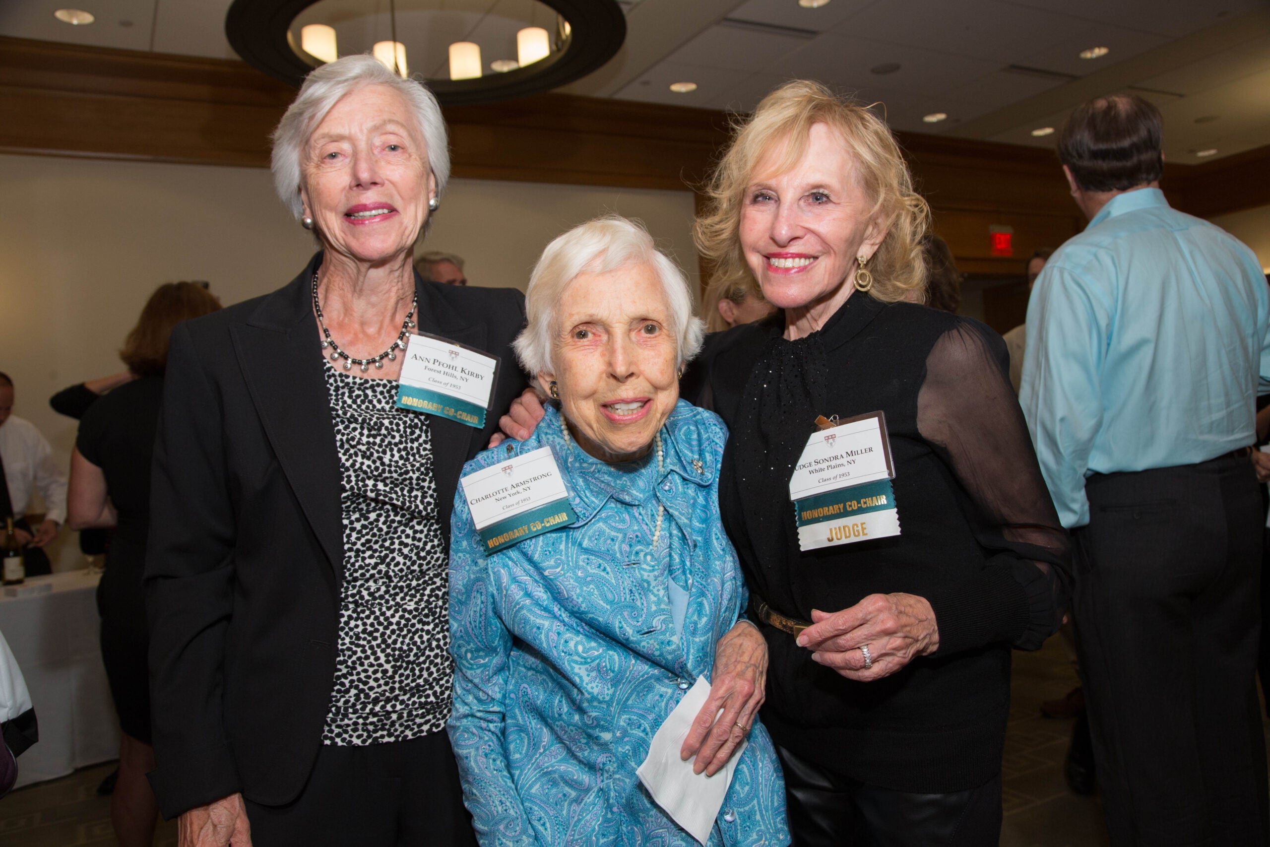 Three women standing together, embracing