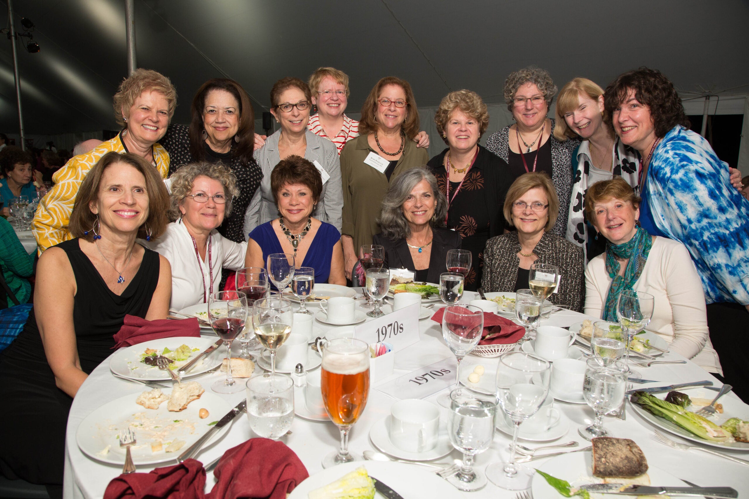Large group of people posting at a dinner table