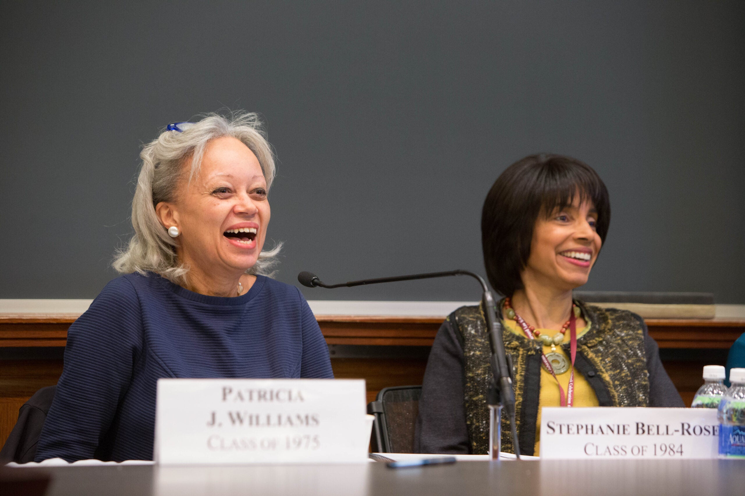 Two people smiling on a panel