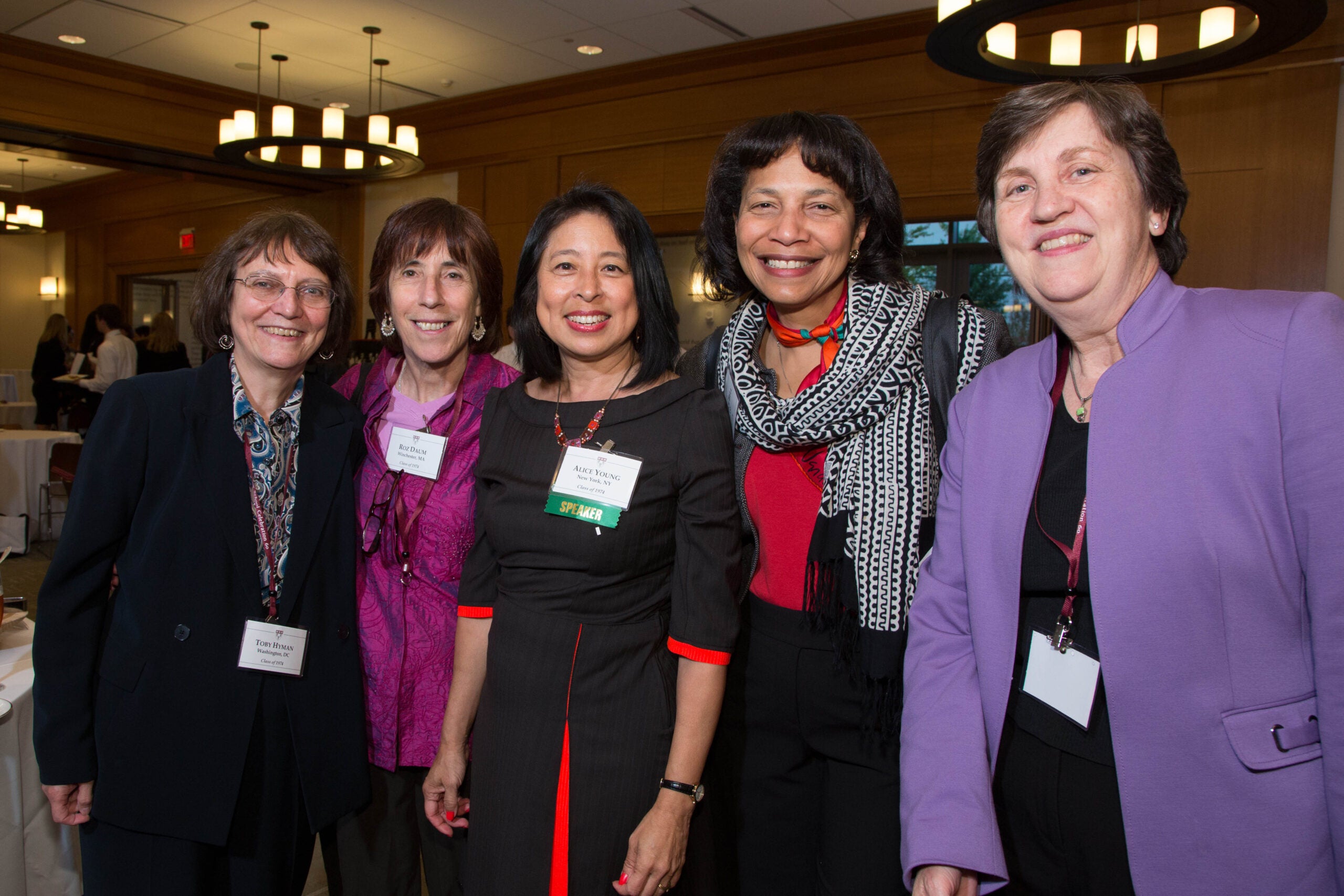 Group of five people smiling together