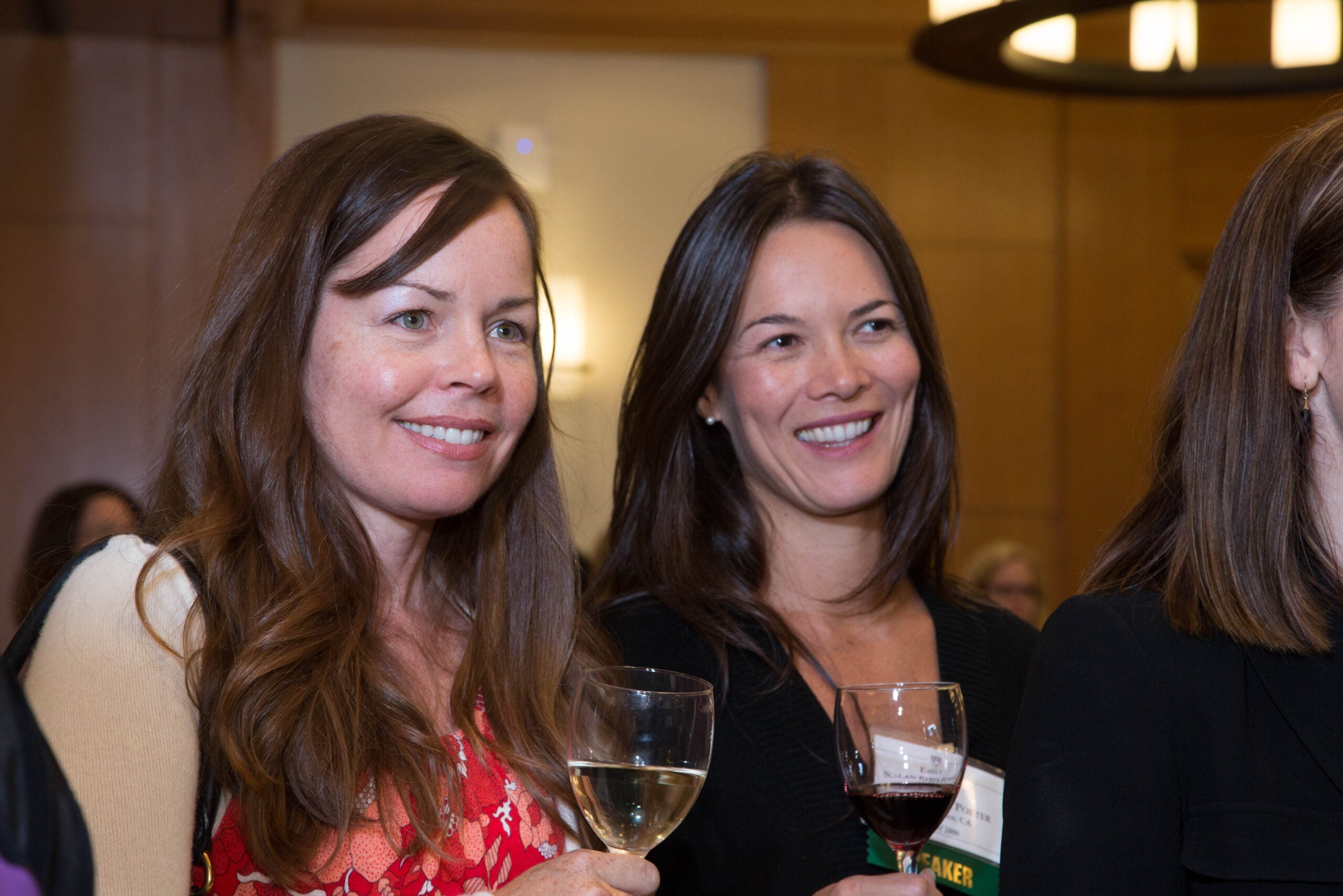 Two people smiling holding drinks