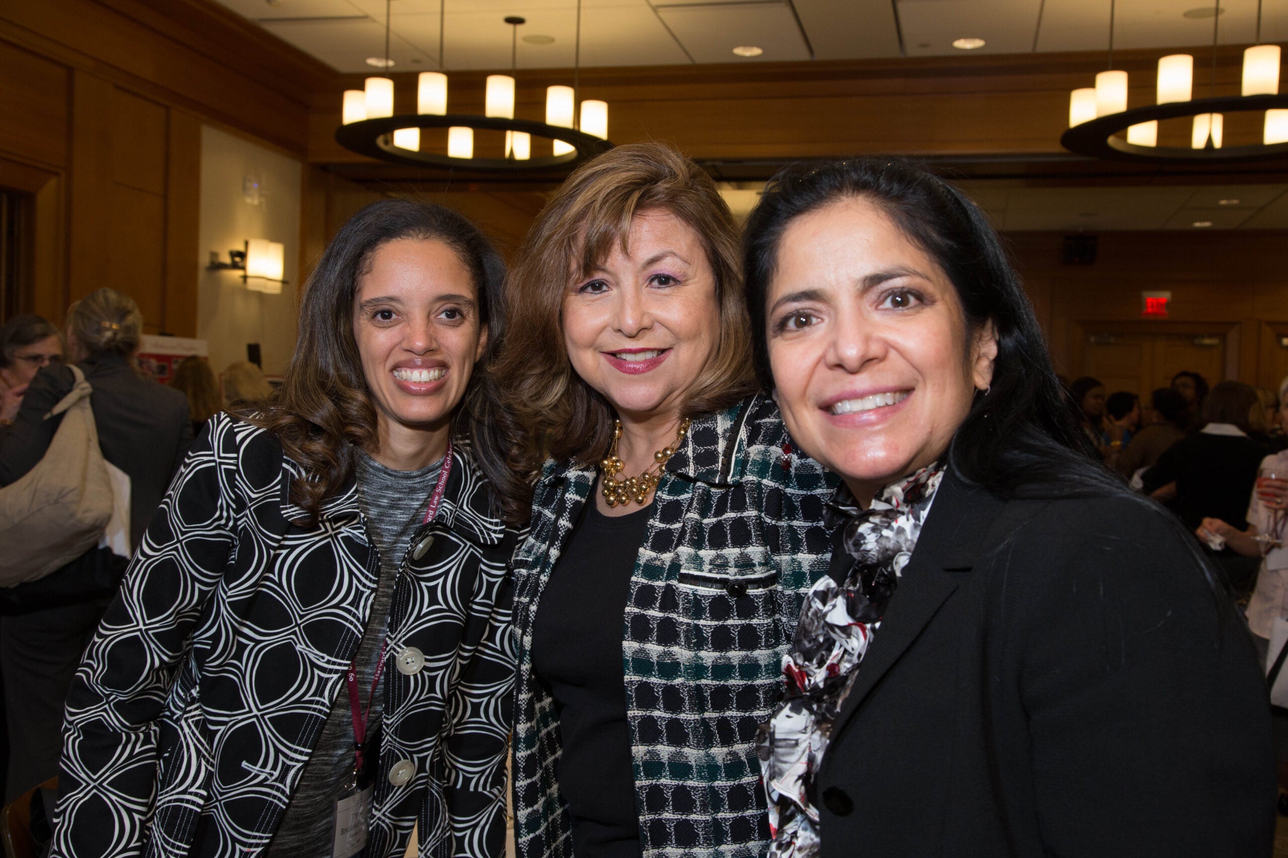 Three people standing together, smiling