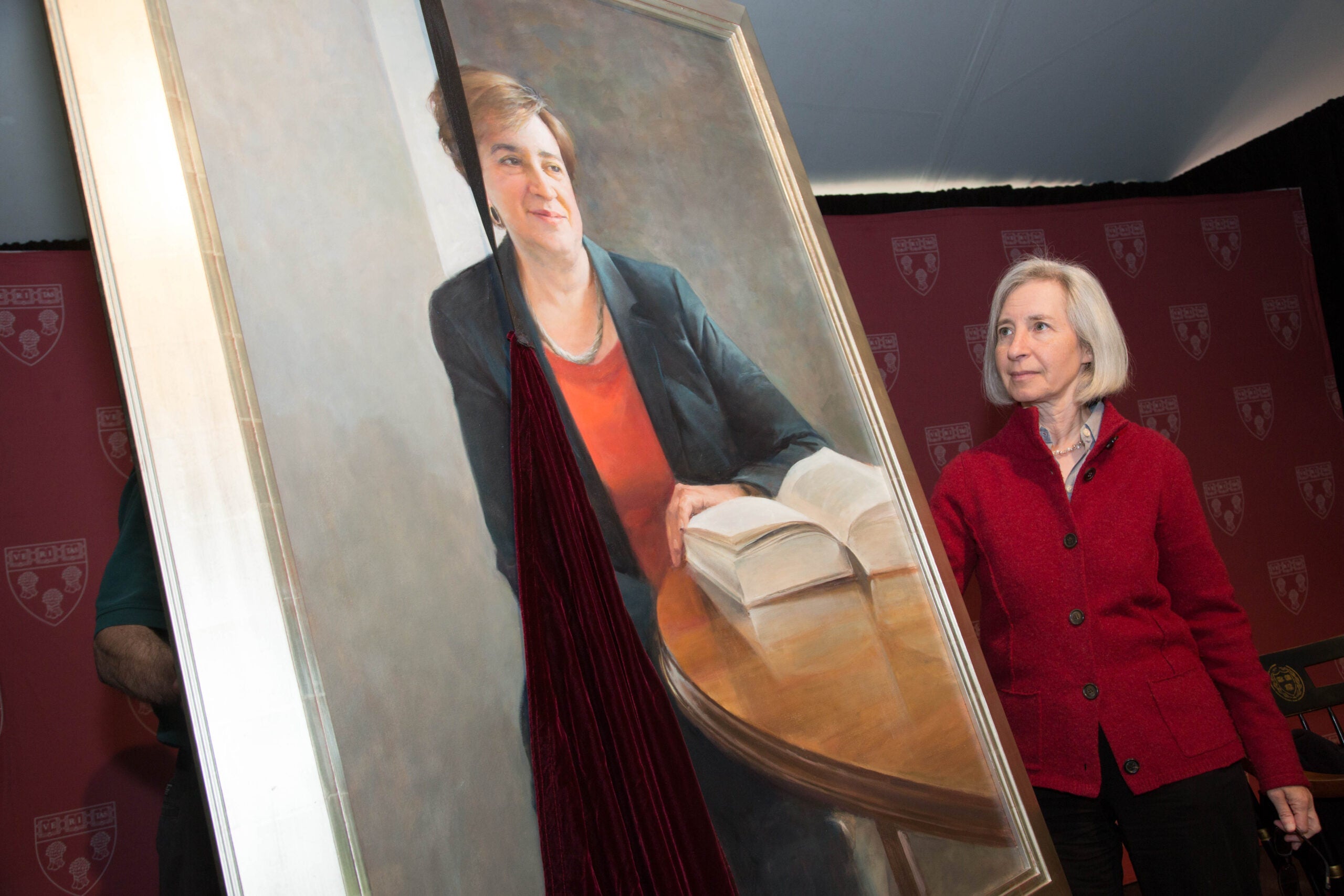 Martha Minow looking at a painting of Elena Kagan