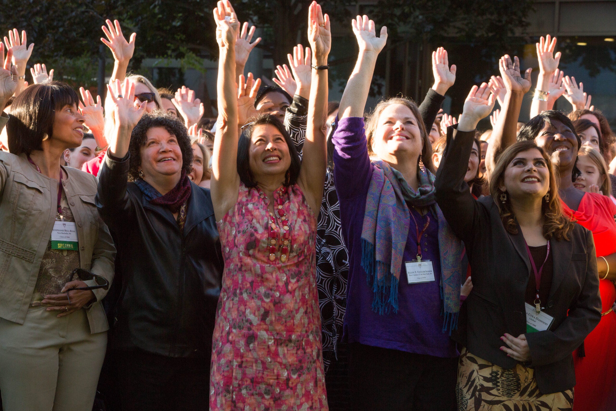 Group of women holding their hands in the air