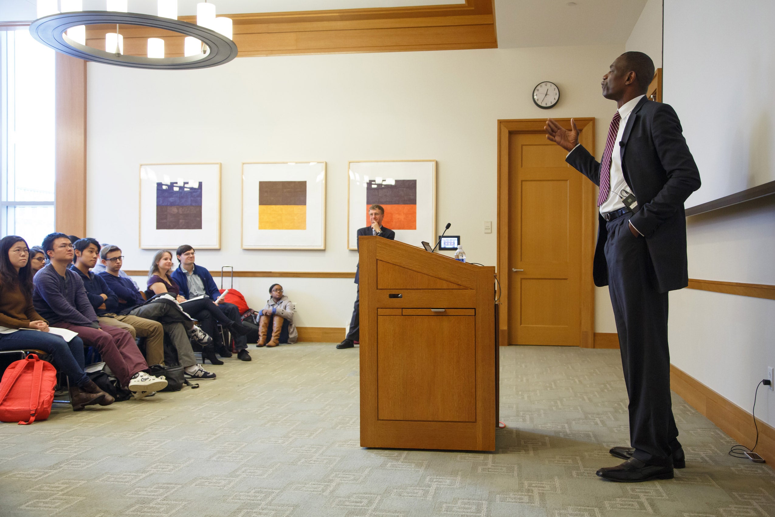 A man standing at a podium speaking to an audience