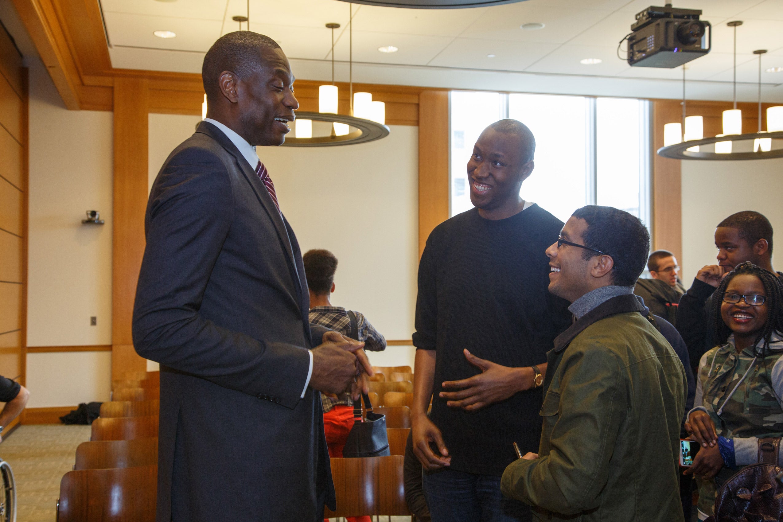 Three men standing together having a conversation