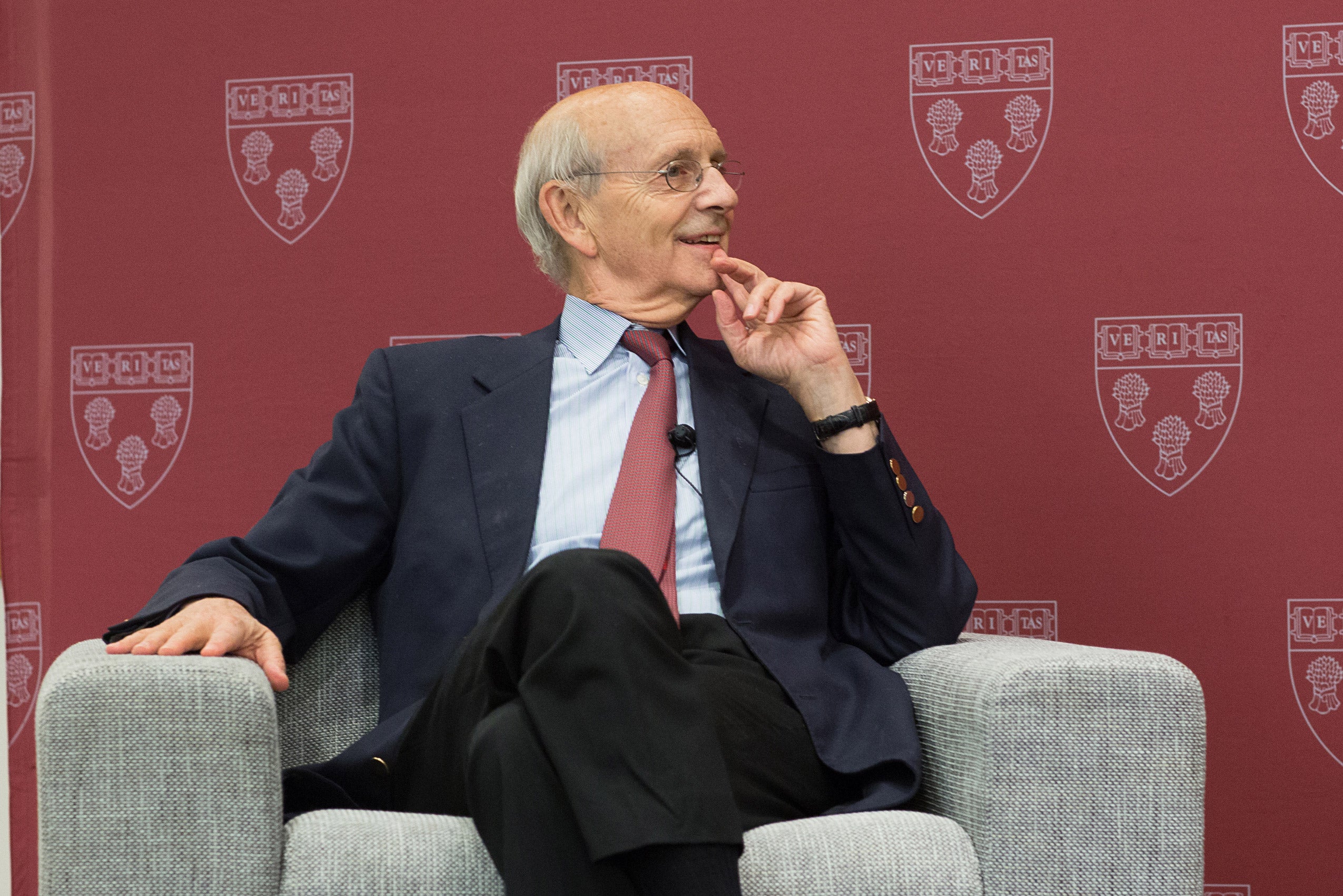 A man seated in an armchair