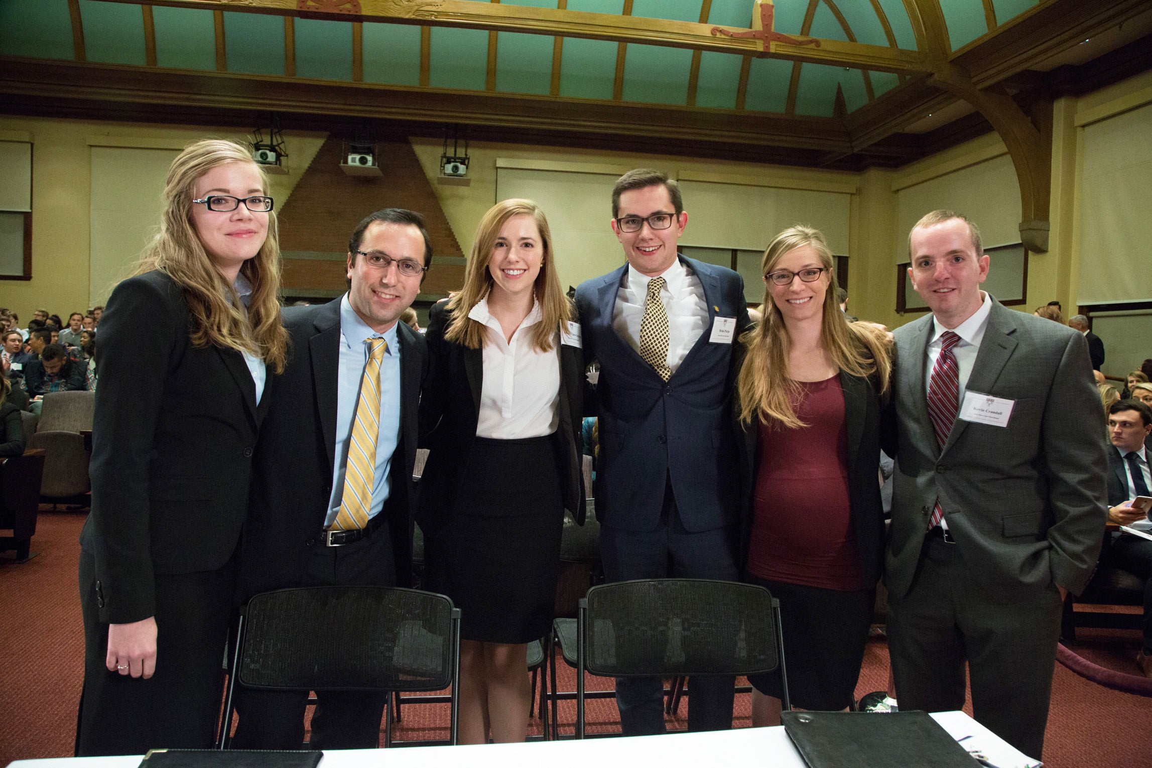 Charlotte Lawson, Gabriel Kohan, Amanda-Claire Grayson, Brian Phelps, Allison Schultz, and Kevin Crandall posing behind their desk