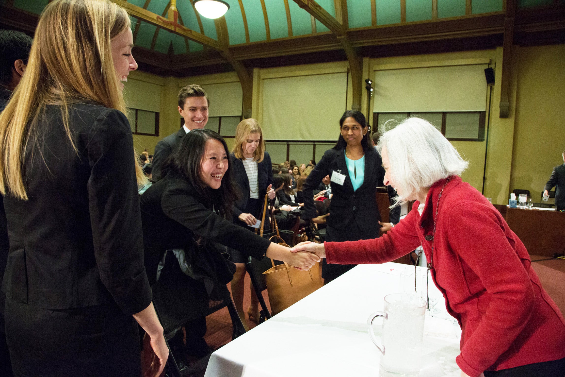 Dean Martha Minow shaking hands with the team