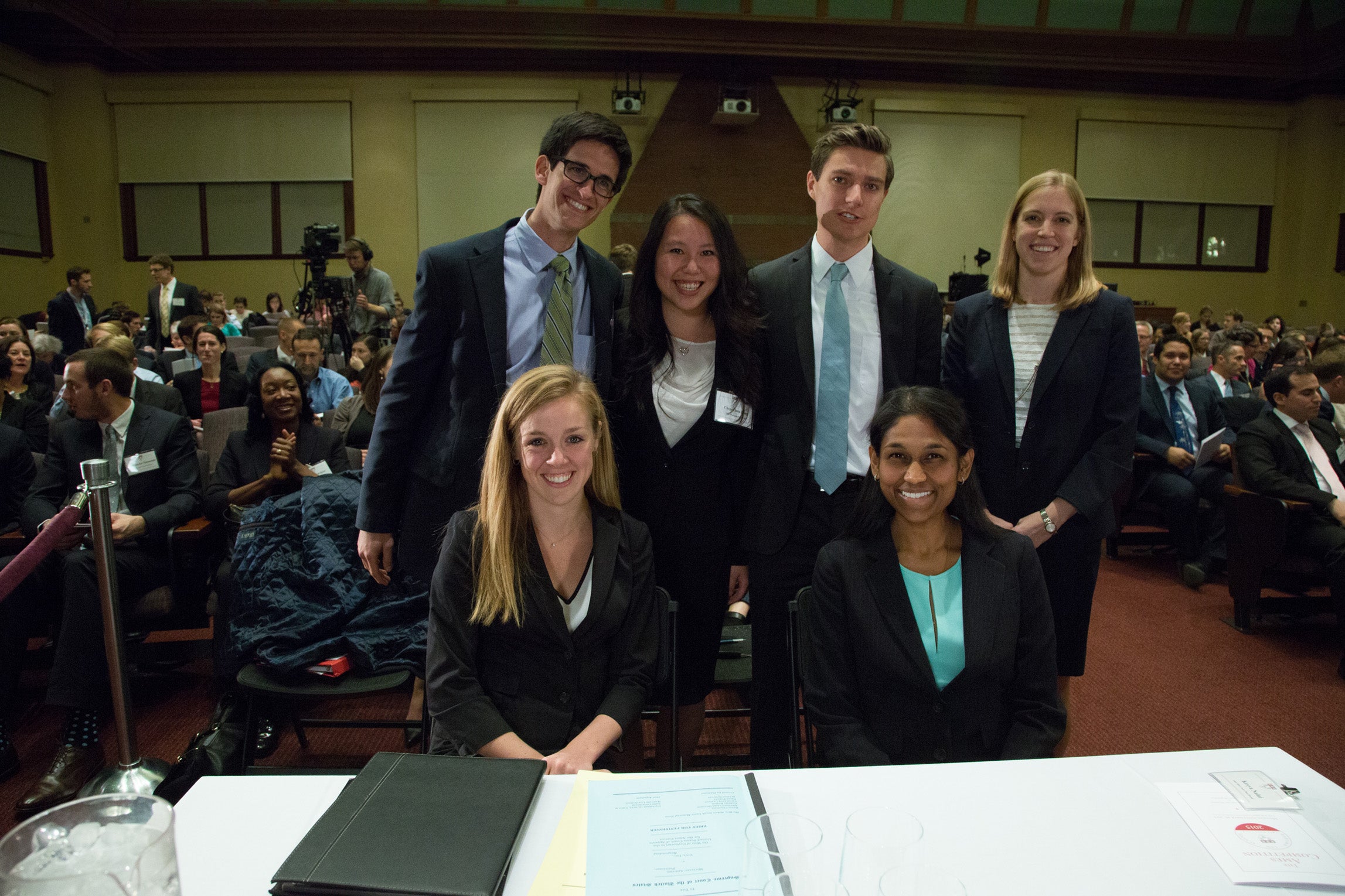 Meghan Cleary, Kavya Naini, Sam Block , Chen-Chen Jiang, Patrick Knoth and Zoe Bedell posing behind their desk