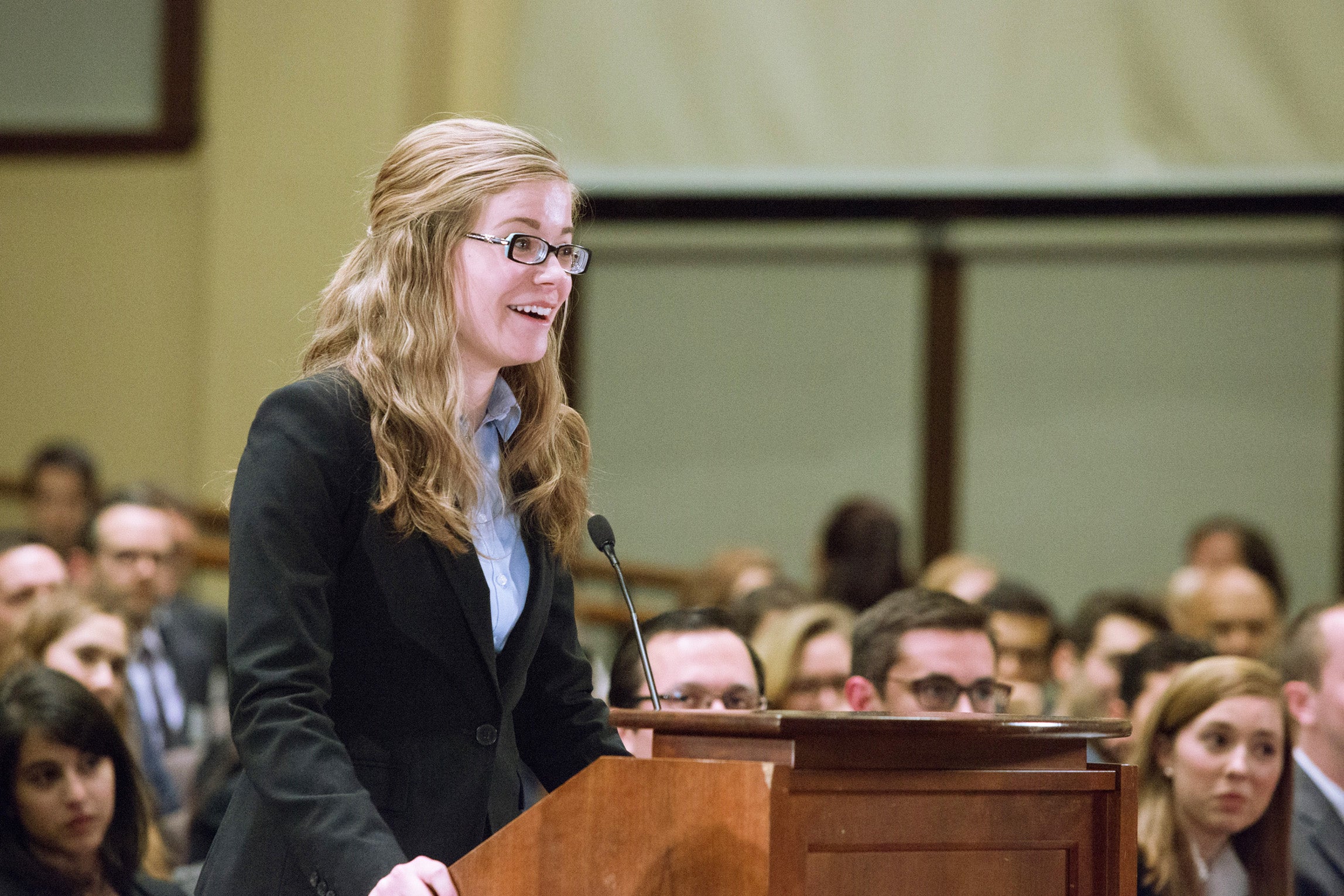 Charlotte Lawson speaking behind the podium