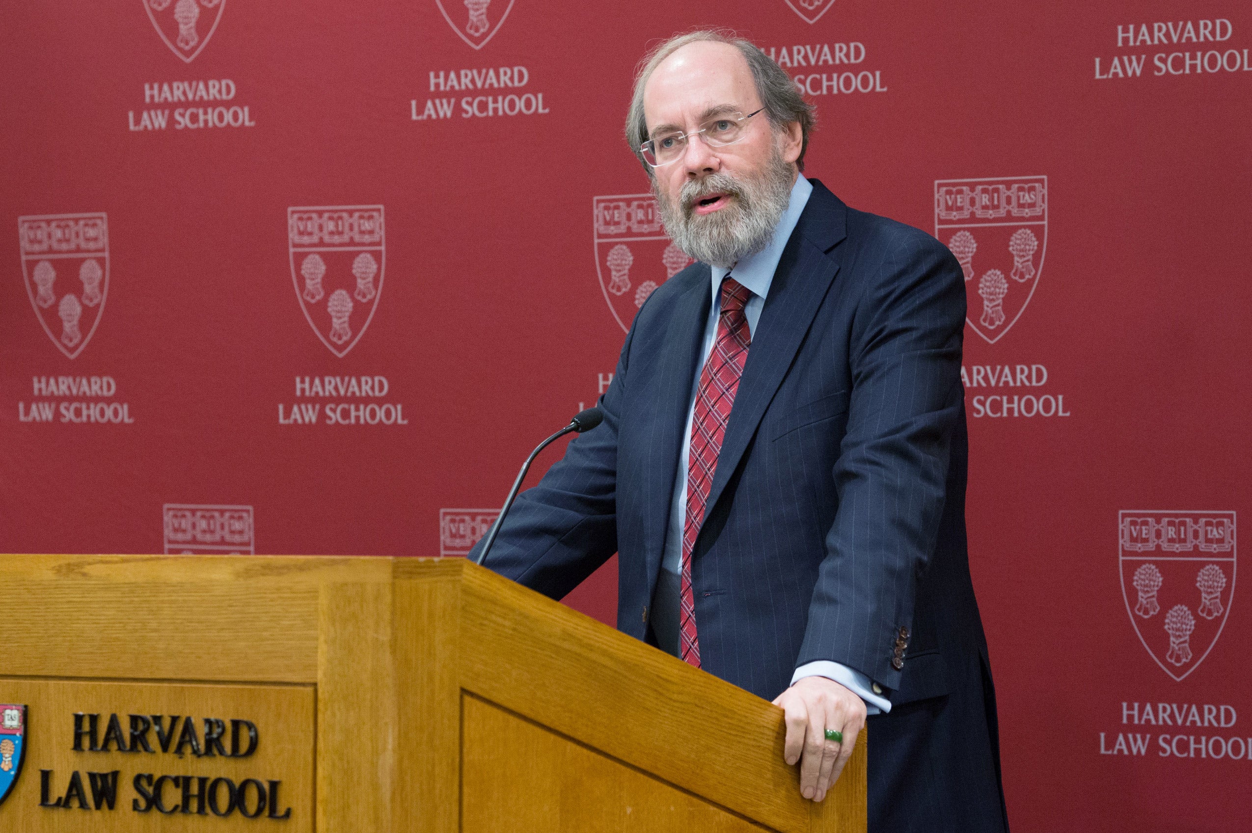 A man standing and speaking at a podium