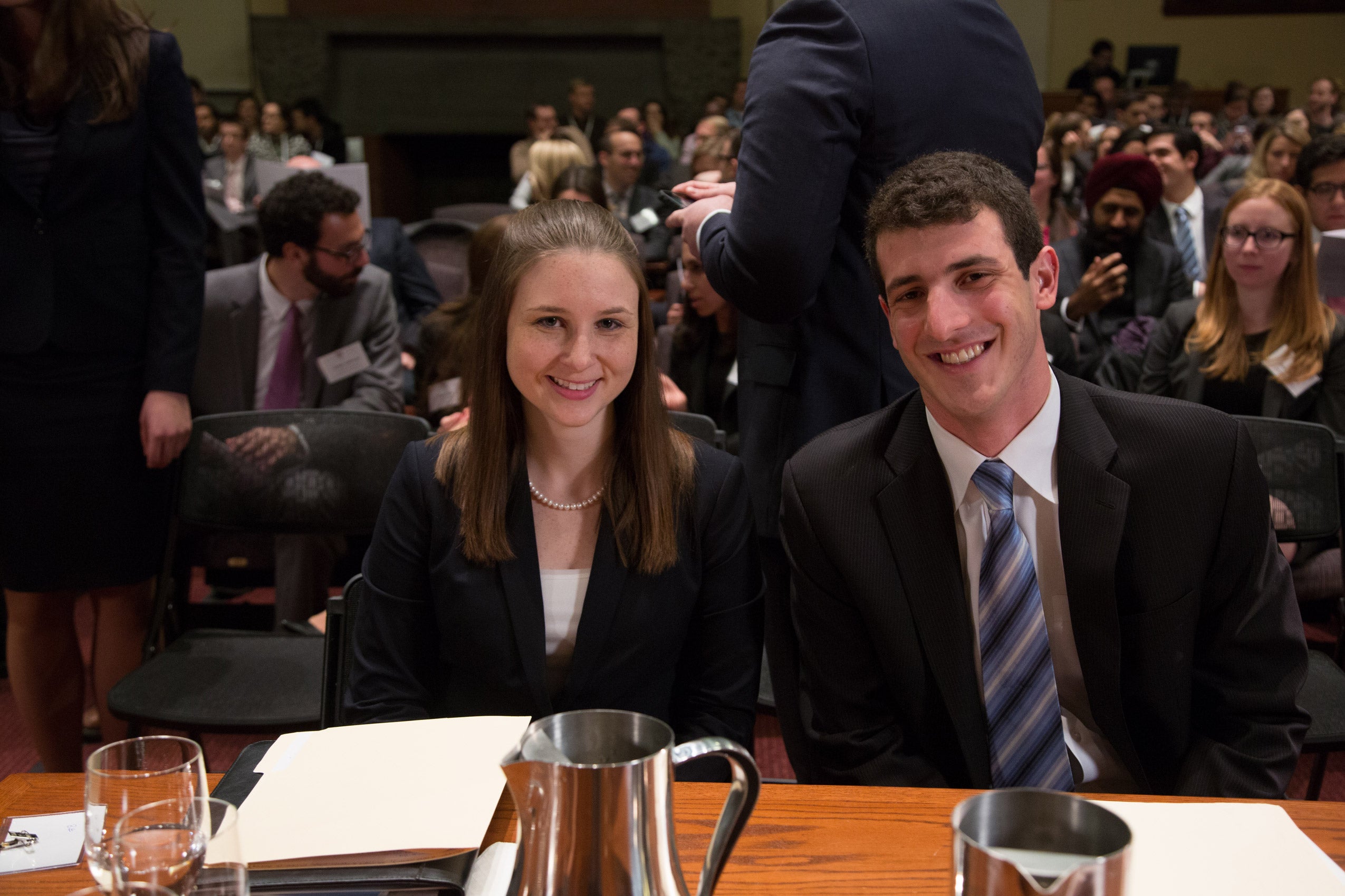 A man and a woman seated and smiling