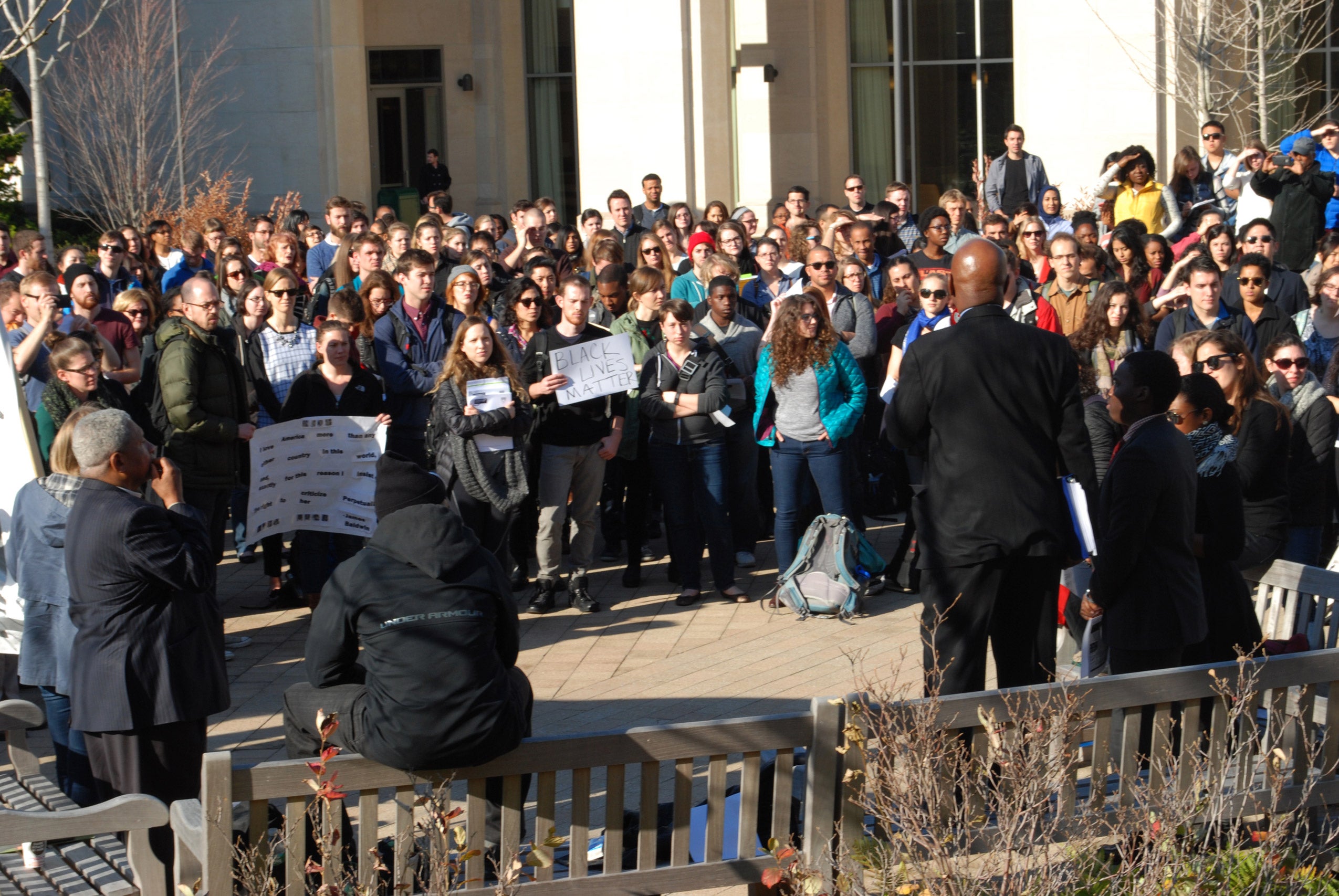 A man speaking to a crowd of protestors