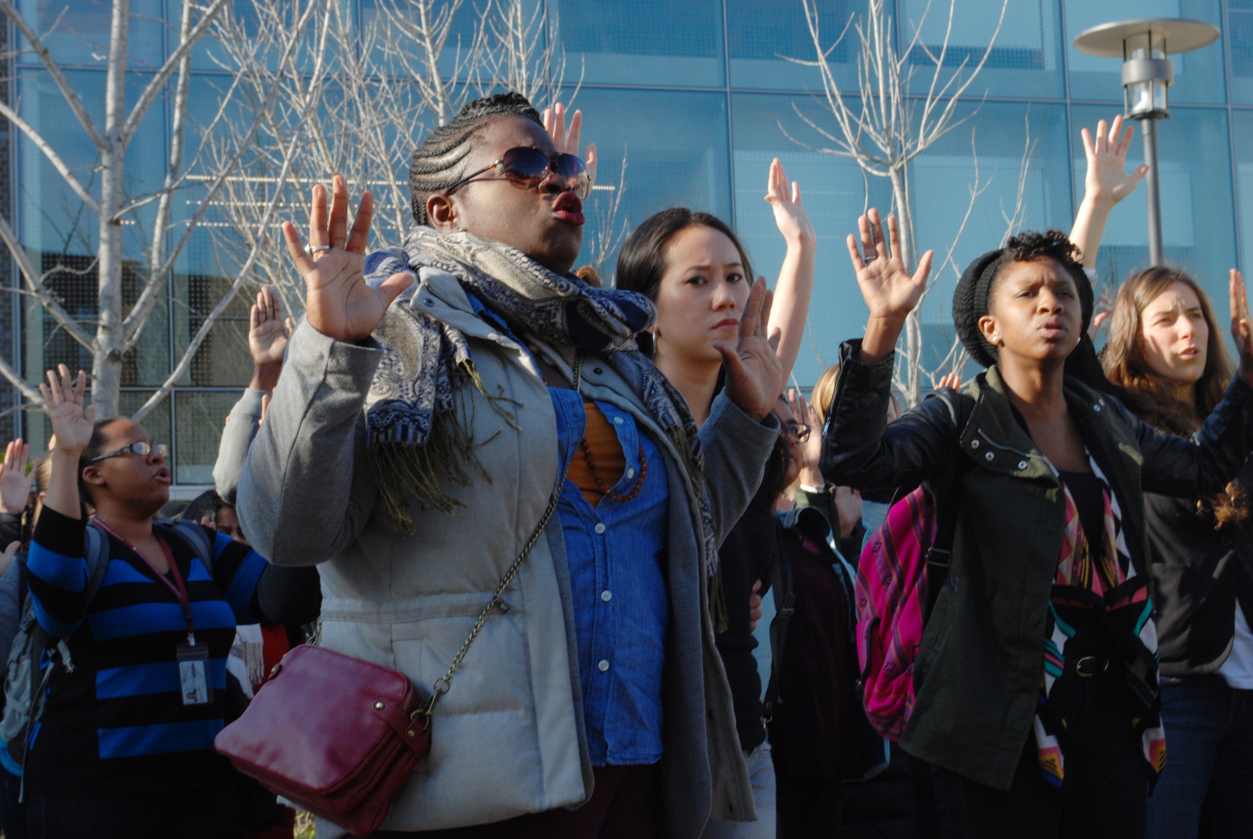 protestors with their hands up
