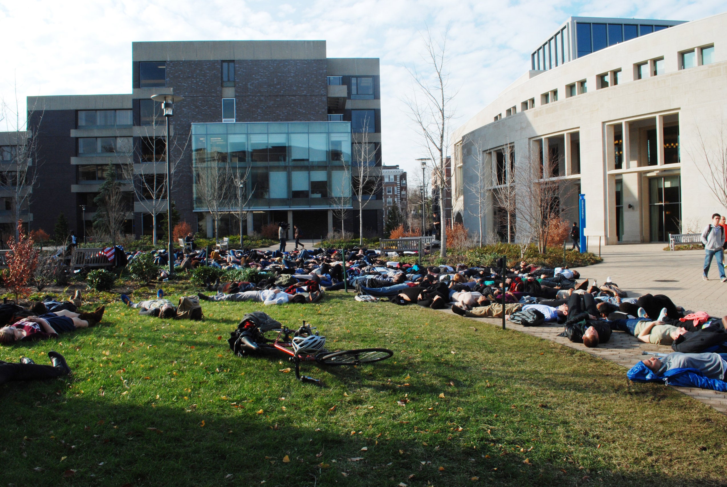 Students participating in a die-in on Kumble Plaza