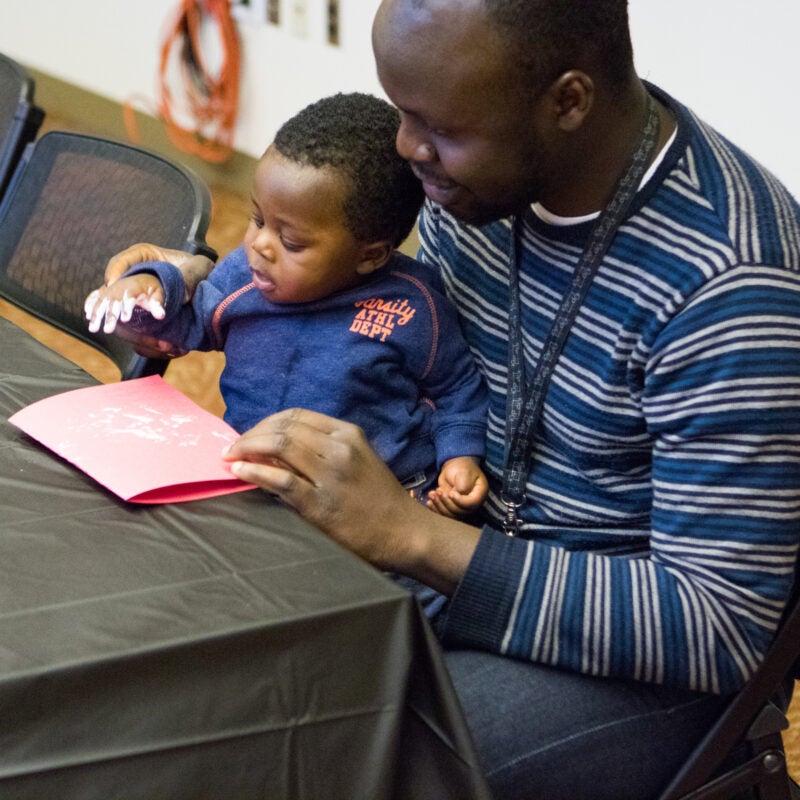 A man holding a baby in his lap