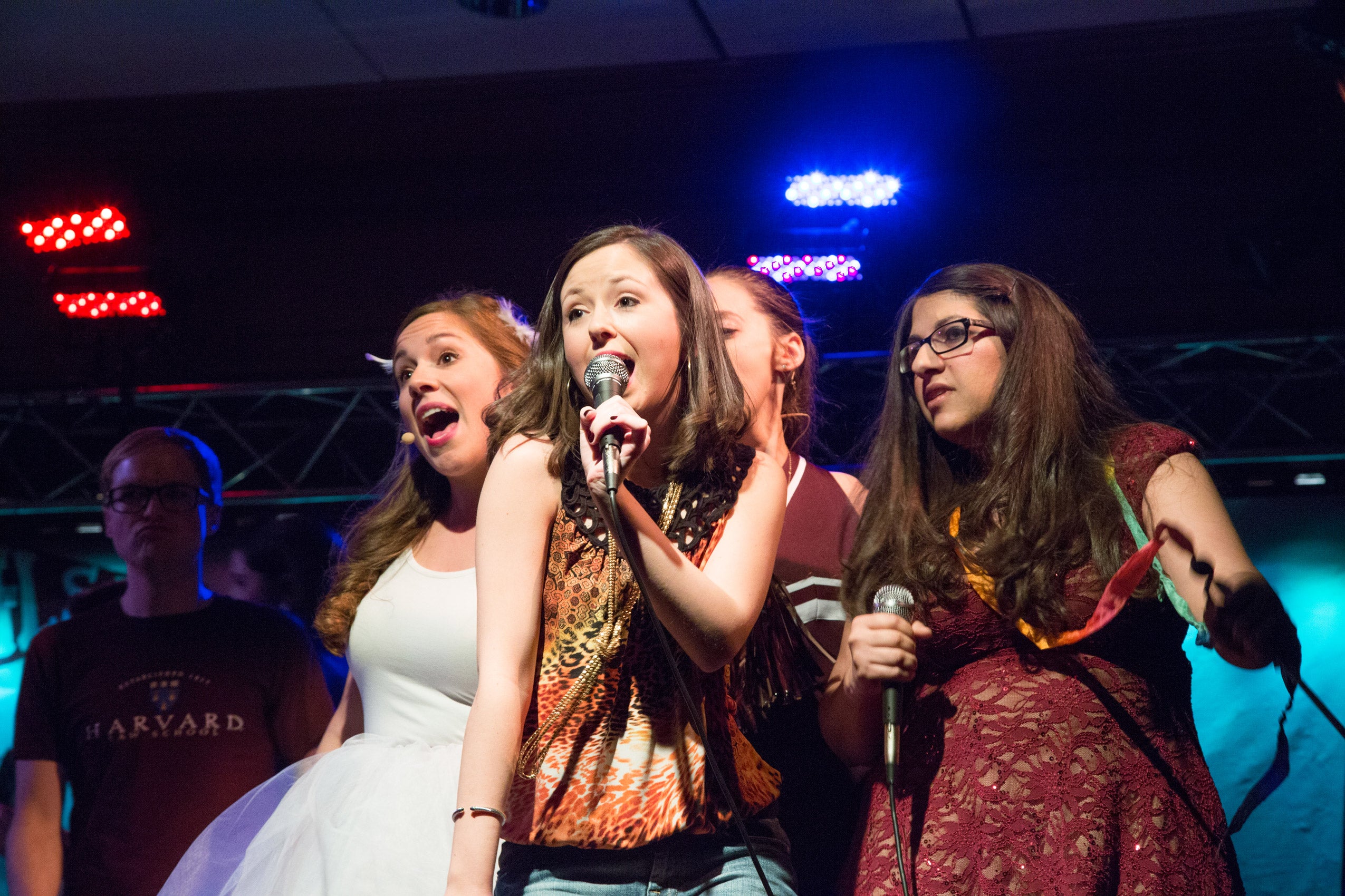 A group of women singing on stage