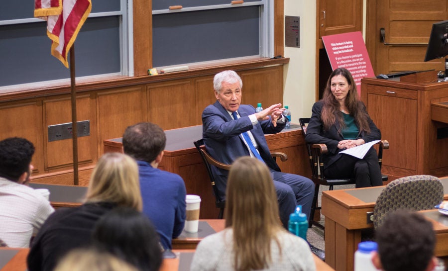 Chuck Hagel and Gabriella Blum speaking to a room of students
