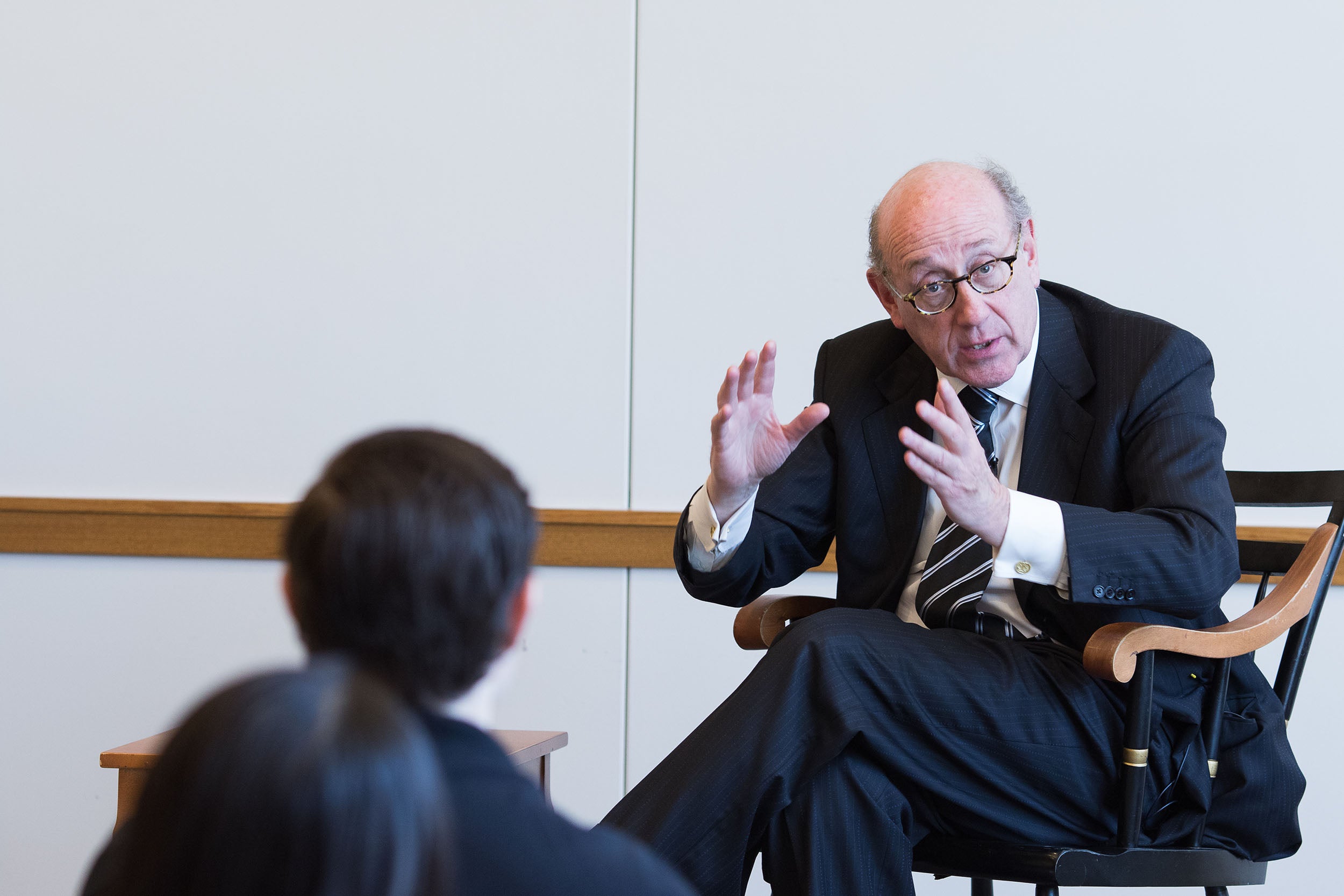 Kenneth Feinberg speaking at the front of the room
