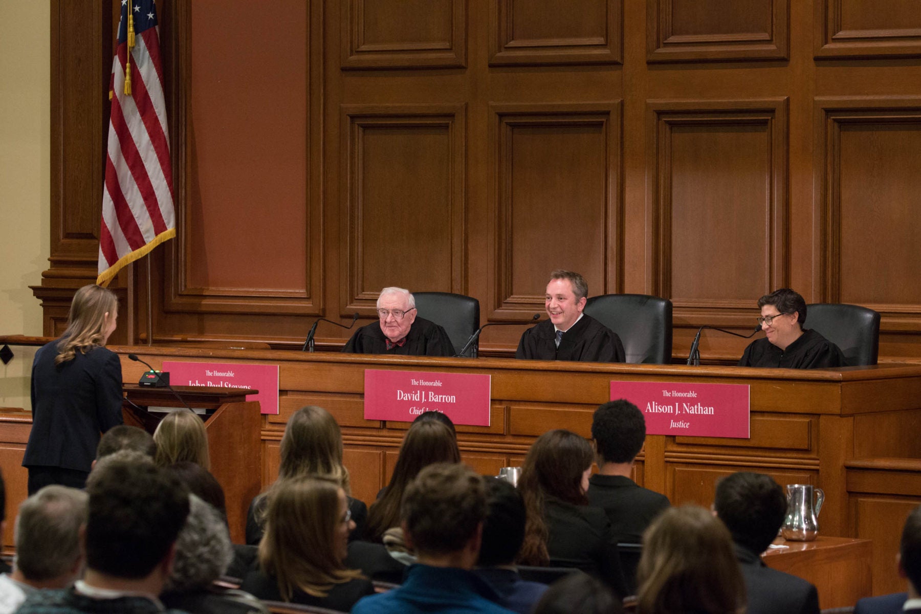 John Paul Stevens, David J. Barron, and Alison J. Nathan in robes at the front of the room