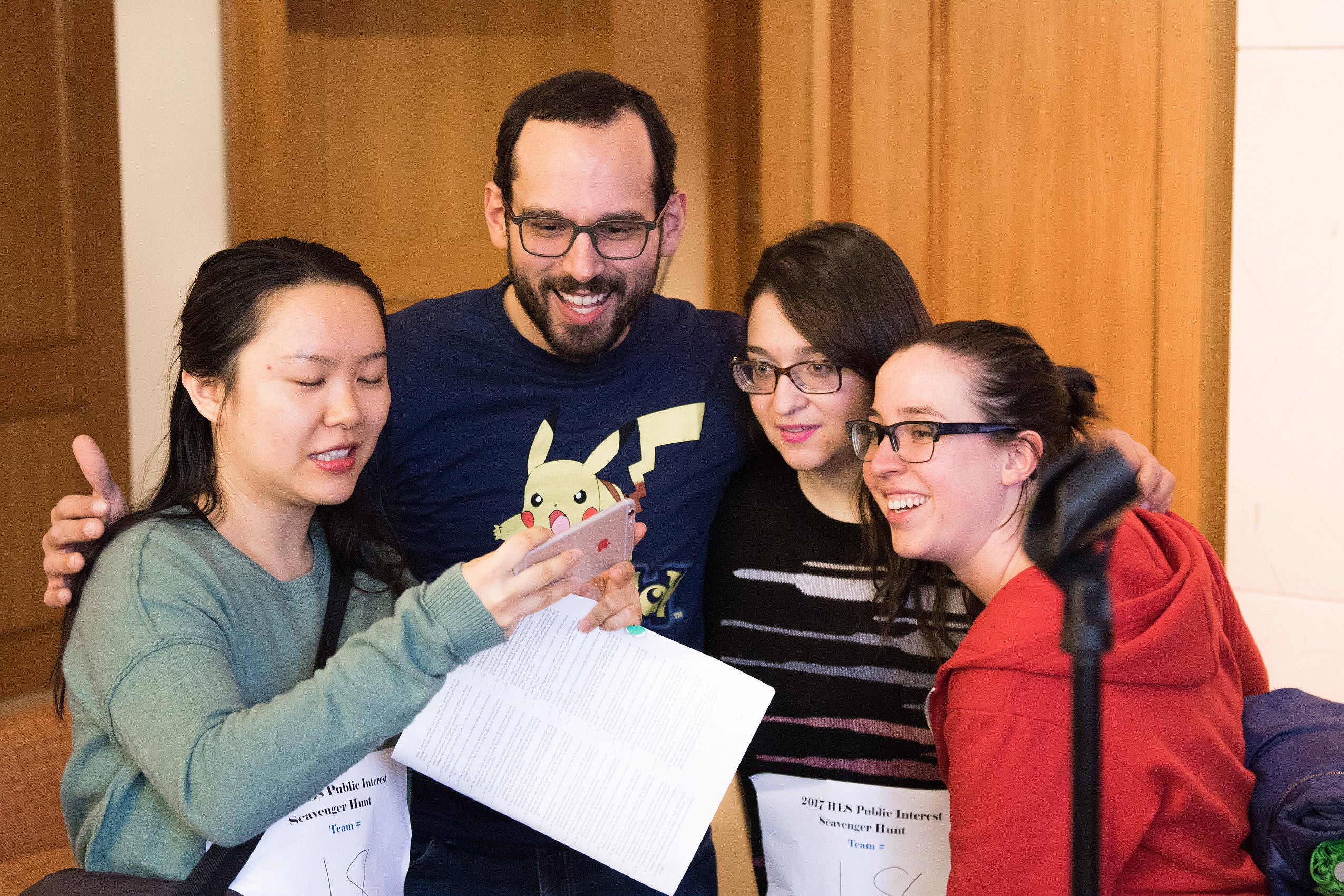 A group of three women and a man taking a selfie