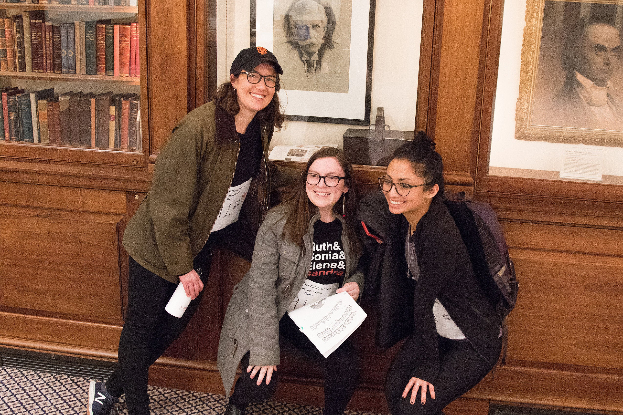 Three women posing for a photo together, smiling