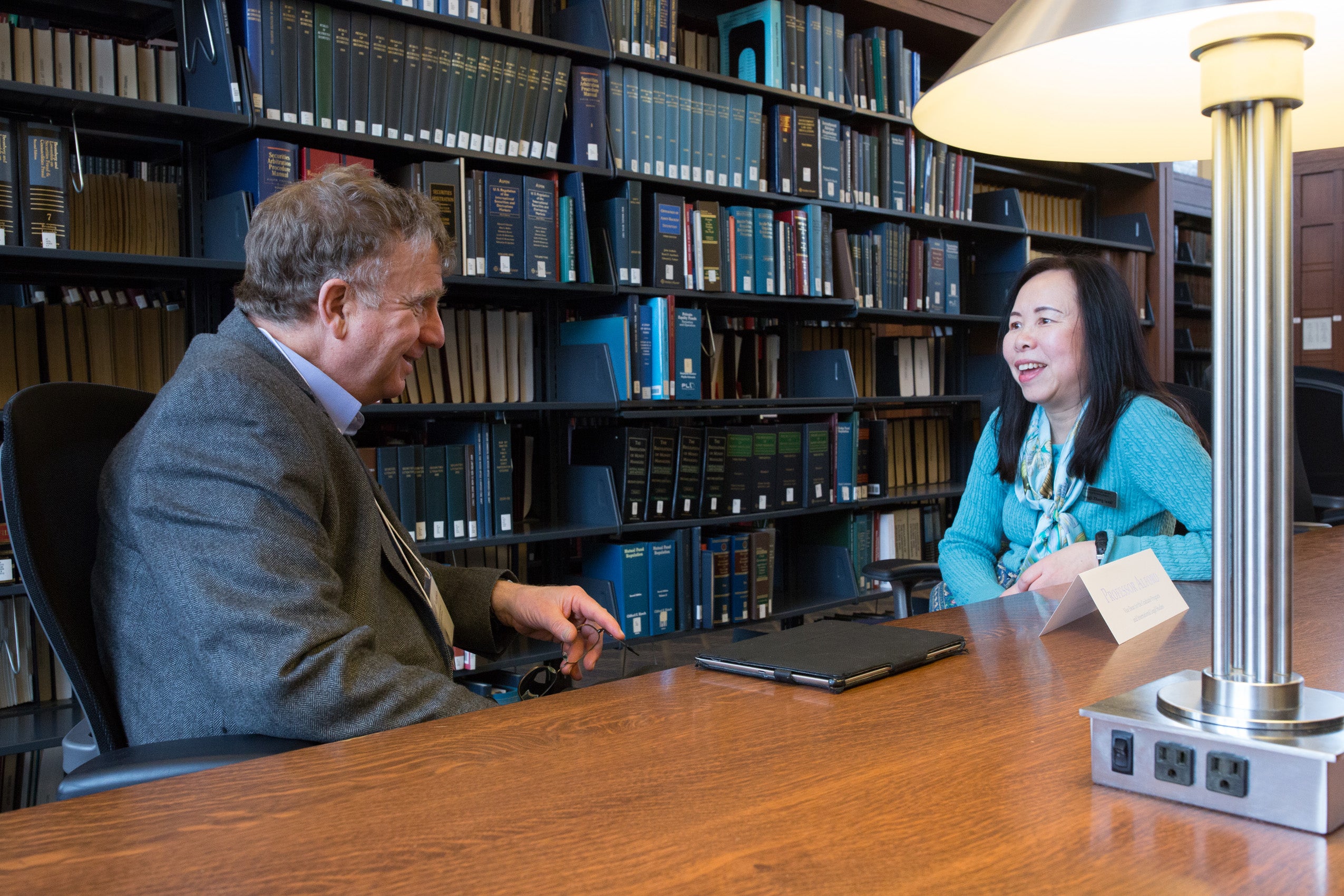A man and a woman sitting at a table having a conversation